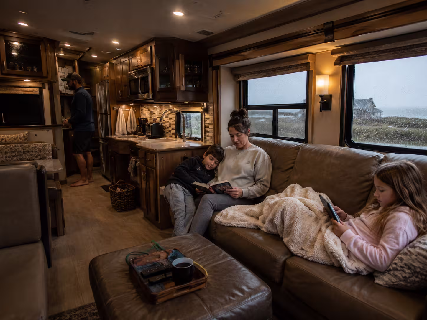 Family relaxing inside a Class A motorhome on an Outer Banks trip