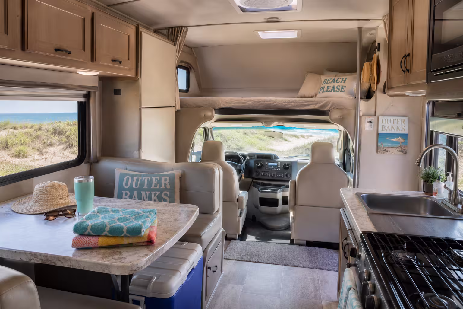 Class C motorhome cab-over bunk and kitchen interior