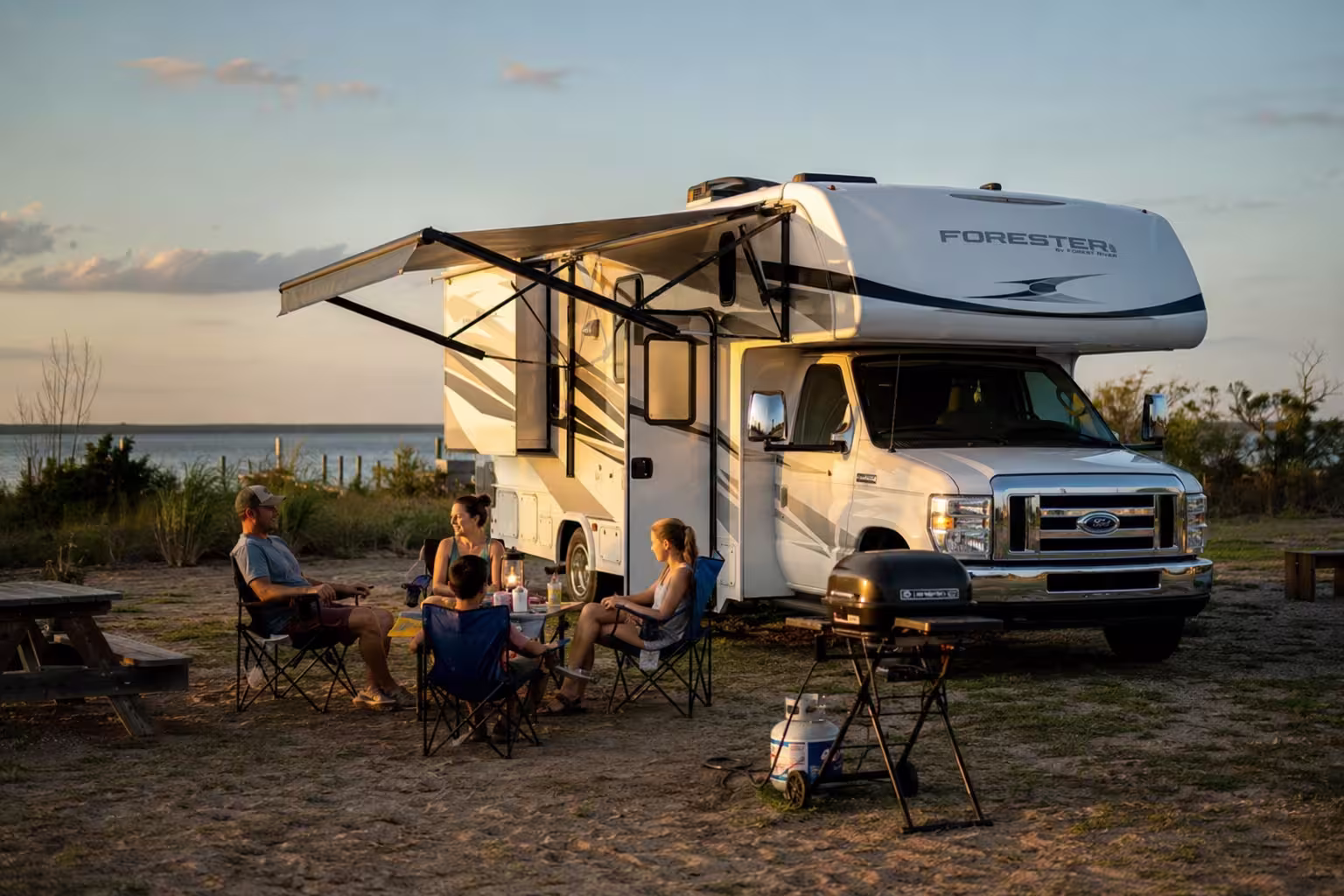 Family beside a rented motorhome at a Cape Hatteras campground