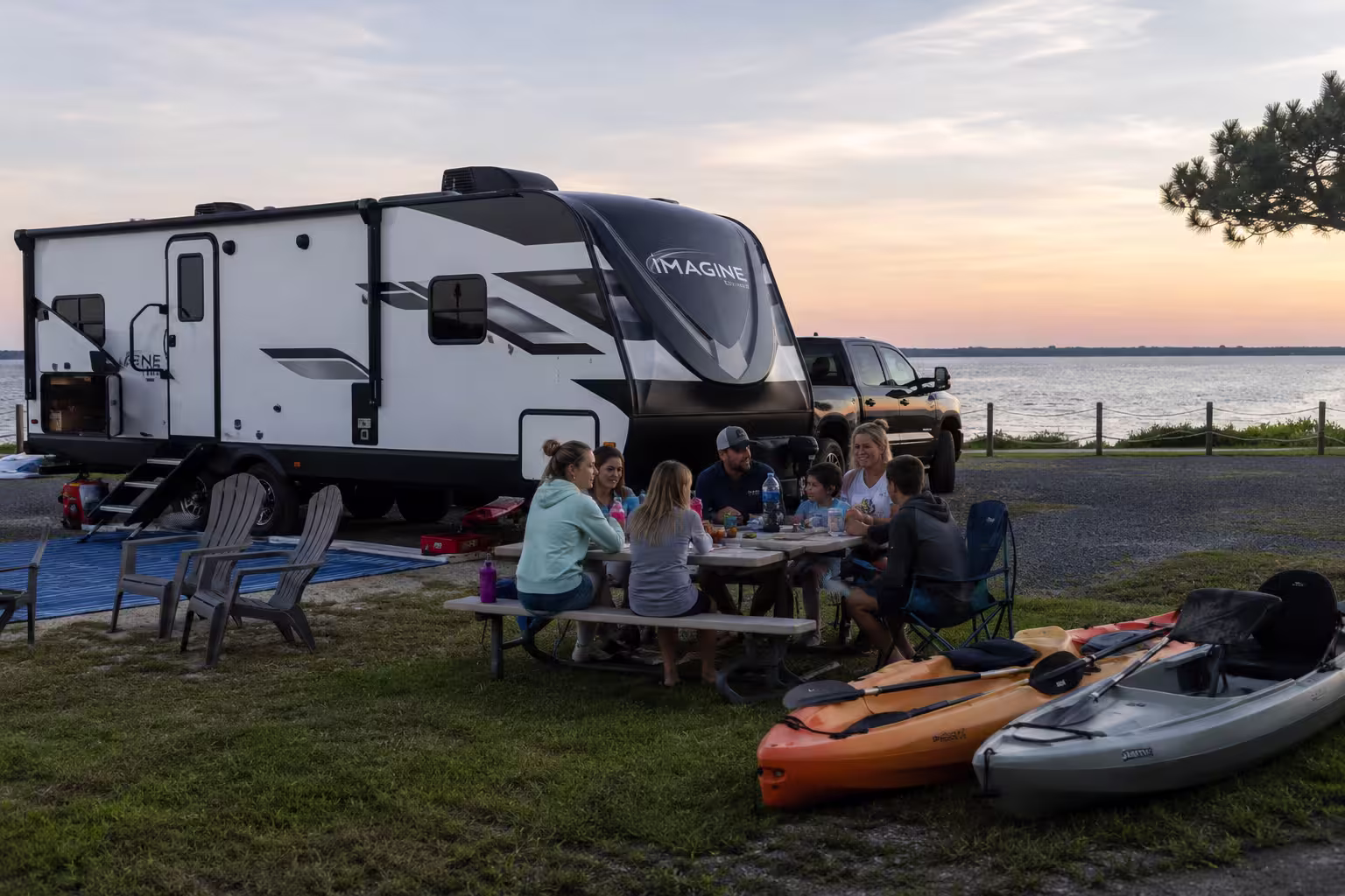 Large travel trailer with a group at a sound-side RV park near Manteo, OBX