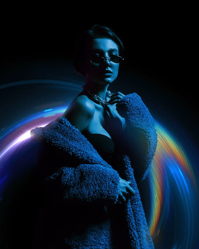 a woman in a bathrobe is standing in the dark
