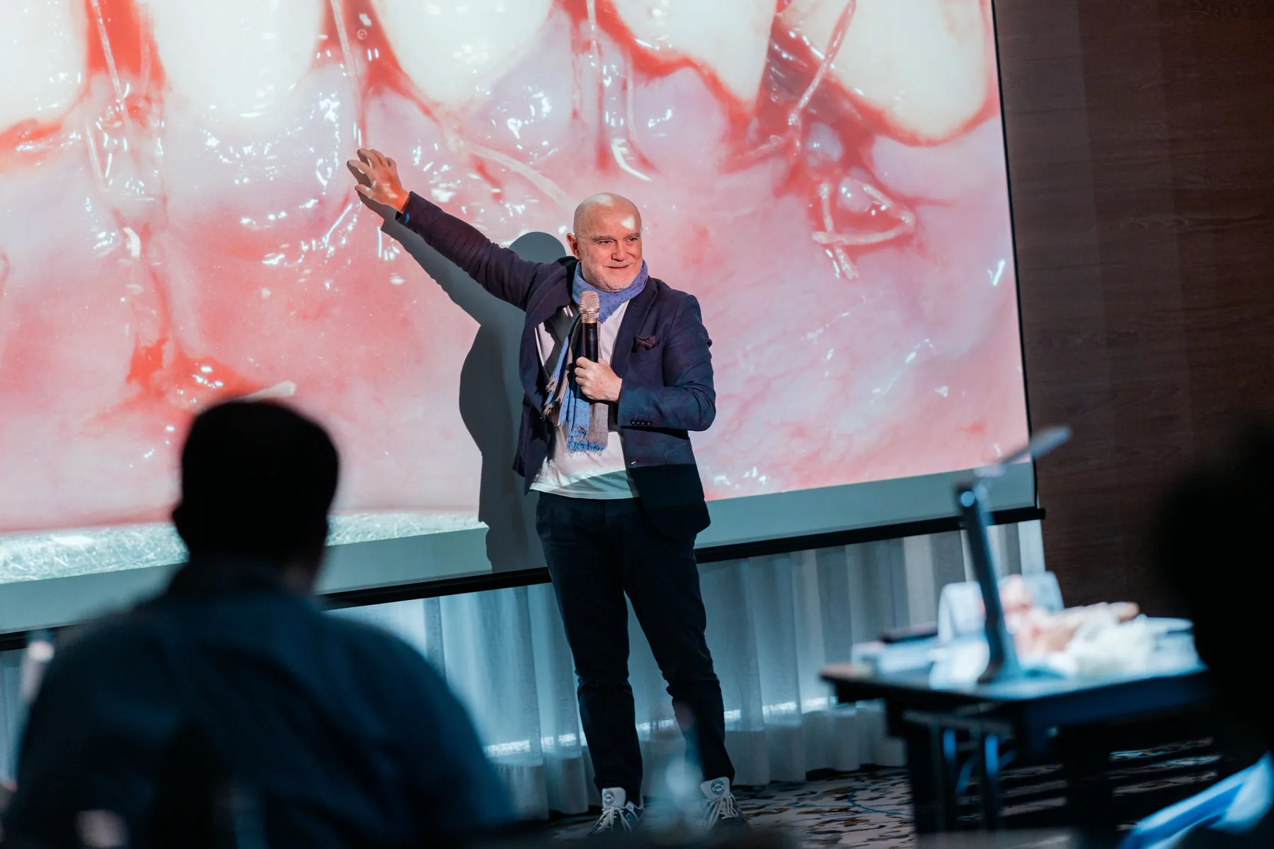 An instructor points to projected clinical images