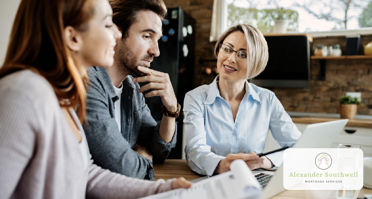 Couple reviewing mortgage documents with a professional broker