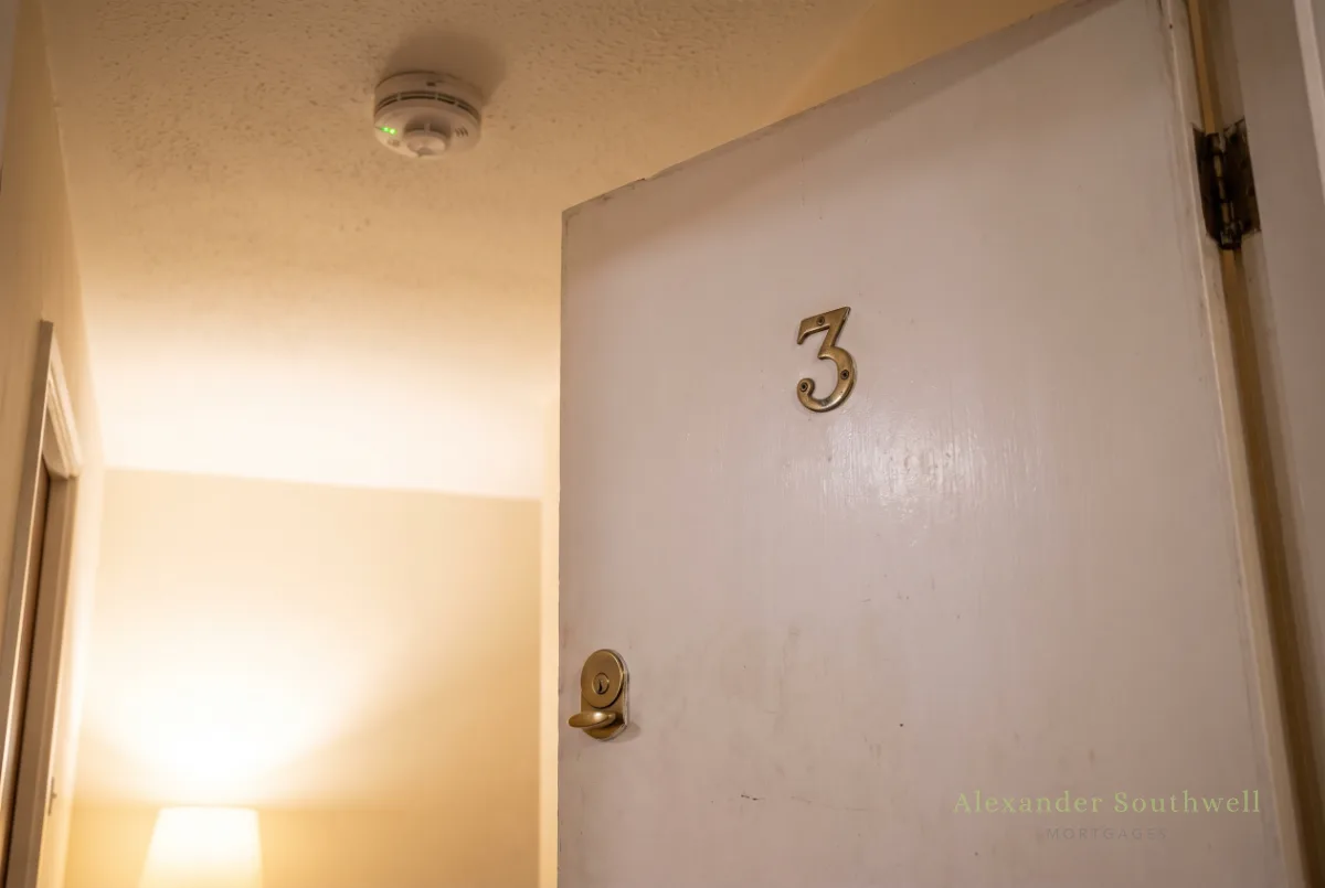 Numbered bedroom fire door and interlinked smoke alarm in a licensed HMO hallway