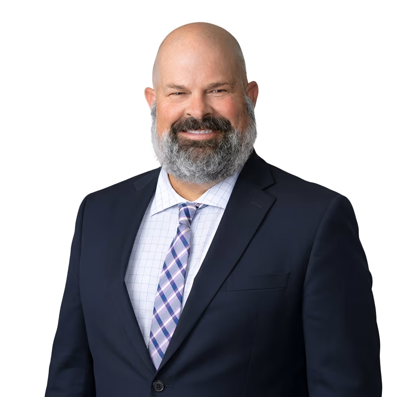 Smiling bald man with a full gray beard wearing a dark suit, white checkered shirt, and purple plaid tie.