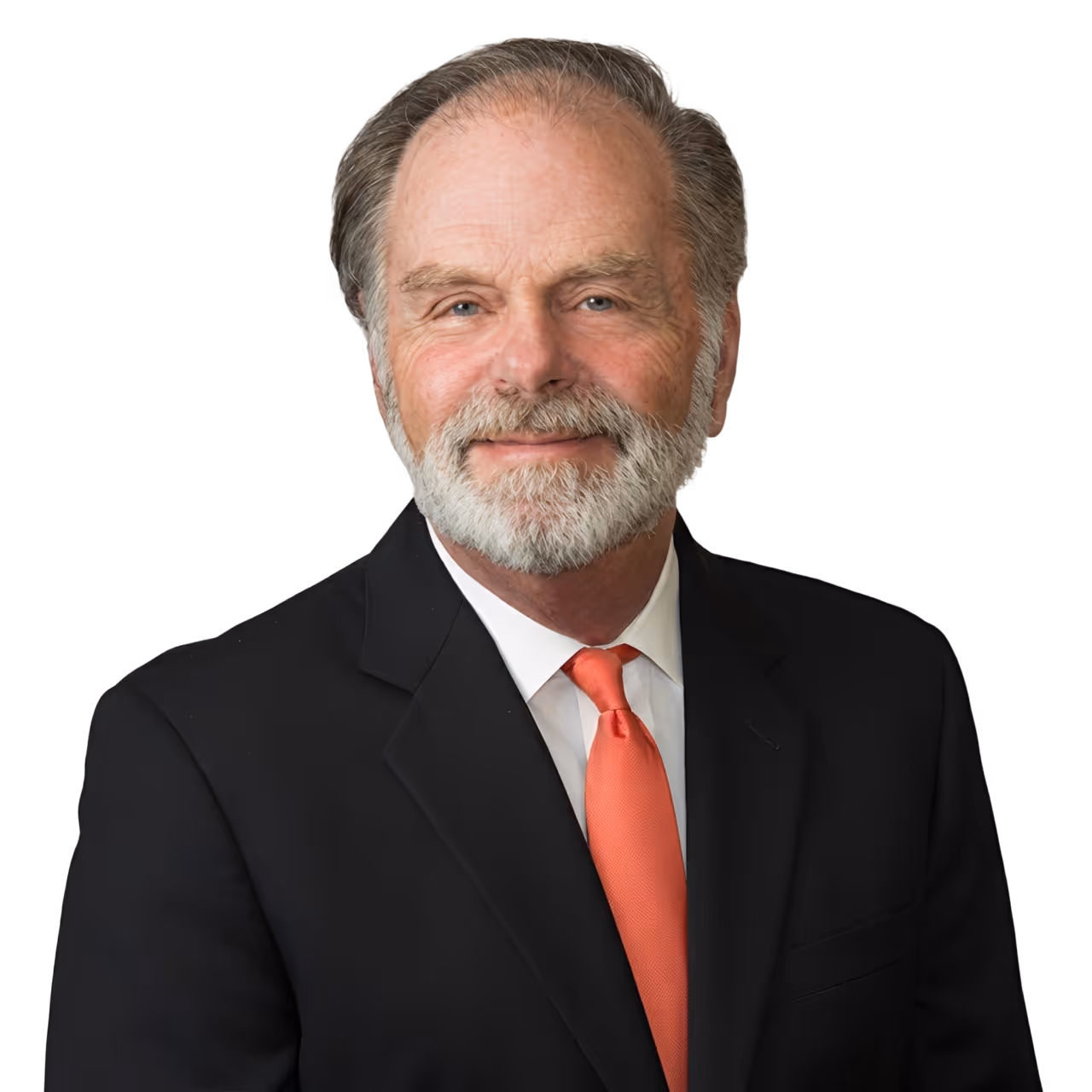 Smiling older man with gray hair and beard wearing a black suit, white shirt, and orange tie.