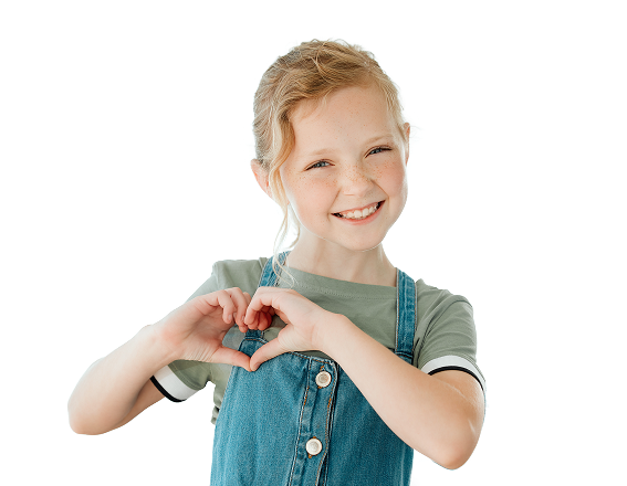Smiling young girl with freckles making a heart shape with her hands.