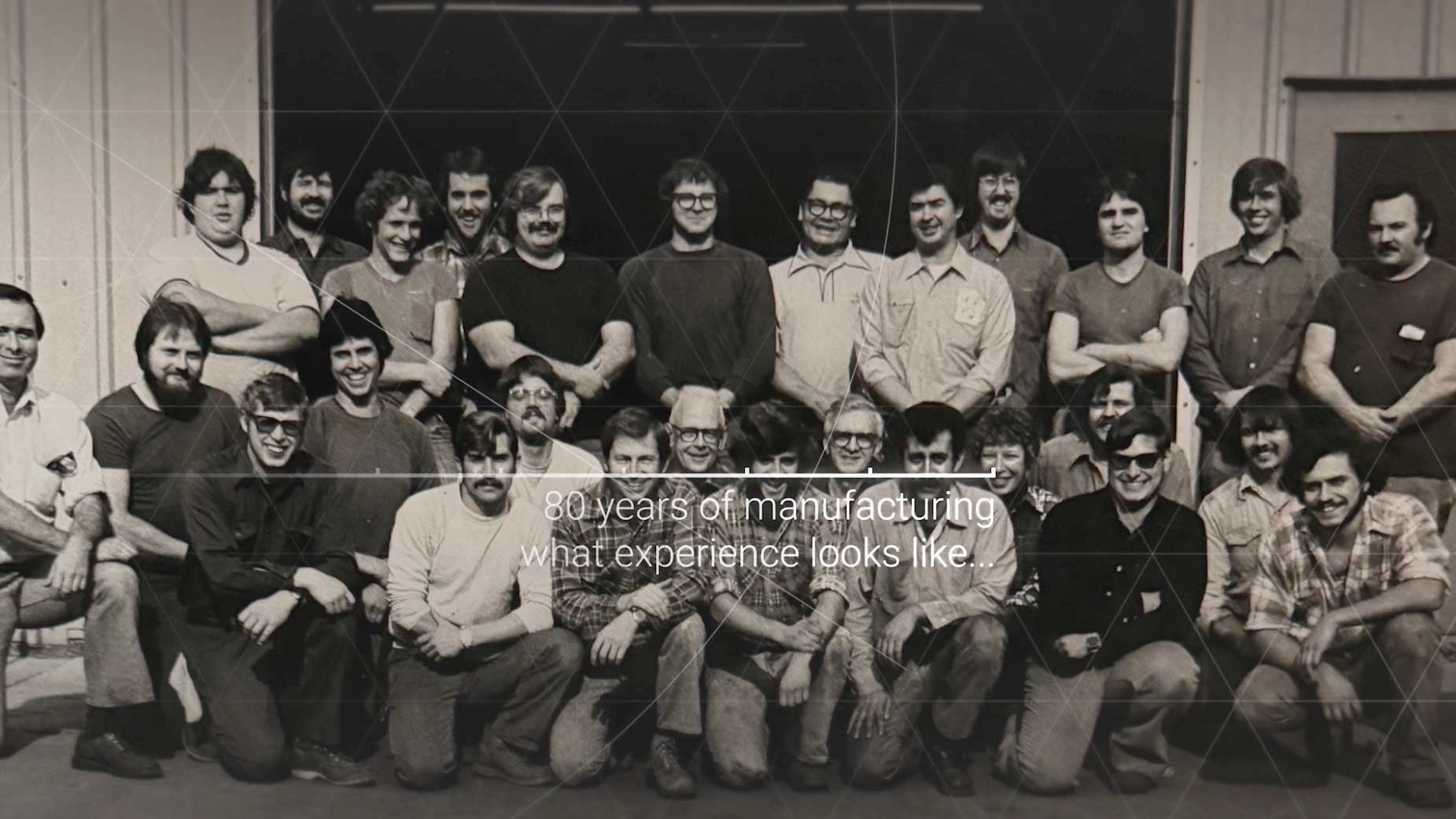 Historic Lindquist Machine Company manufacturing team photo representing 80 years of industrial experience