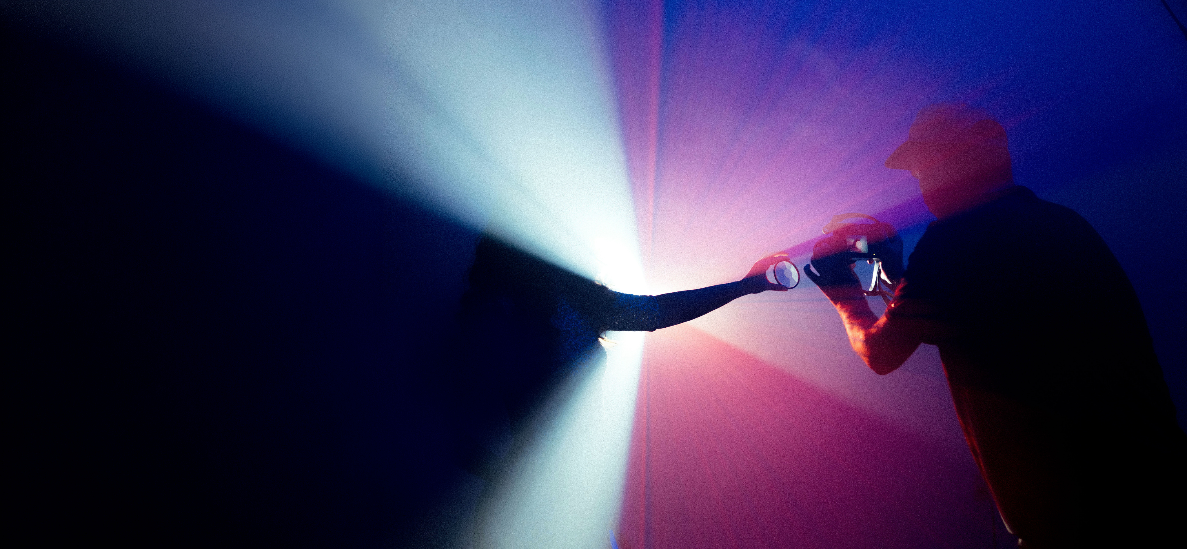 Person reaching toward a bright light, cinematic background