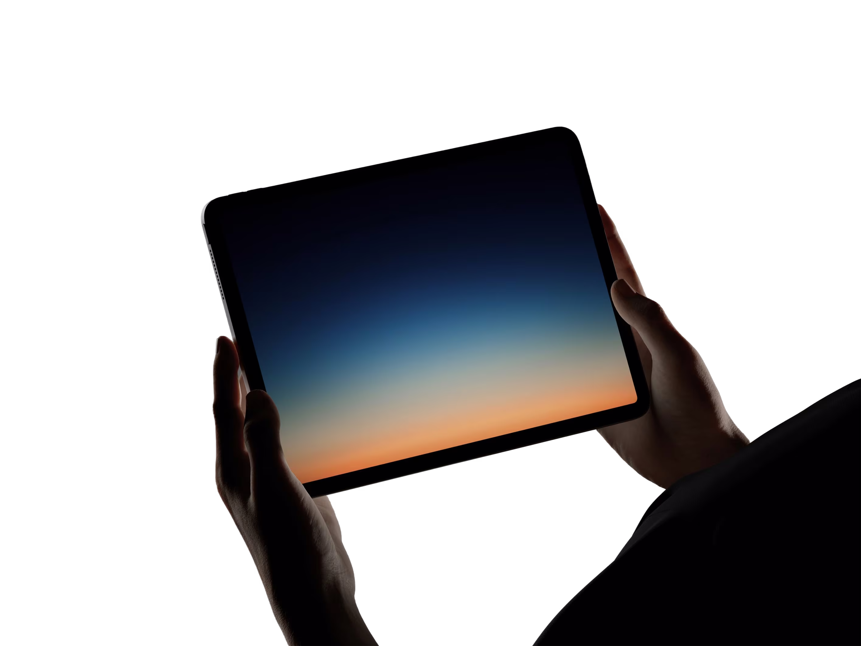 Person holding phone against a sunset sky
