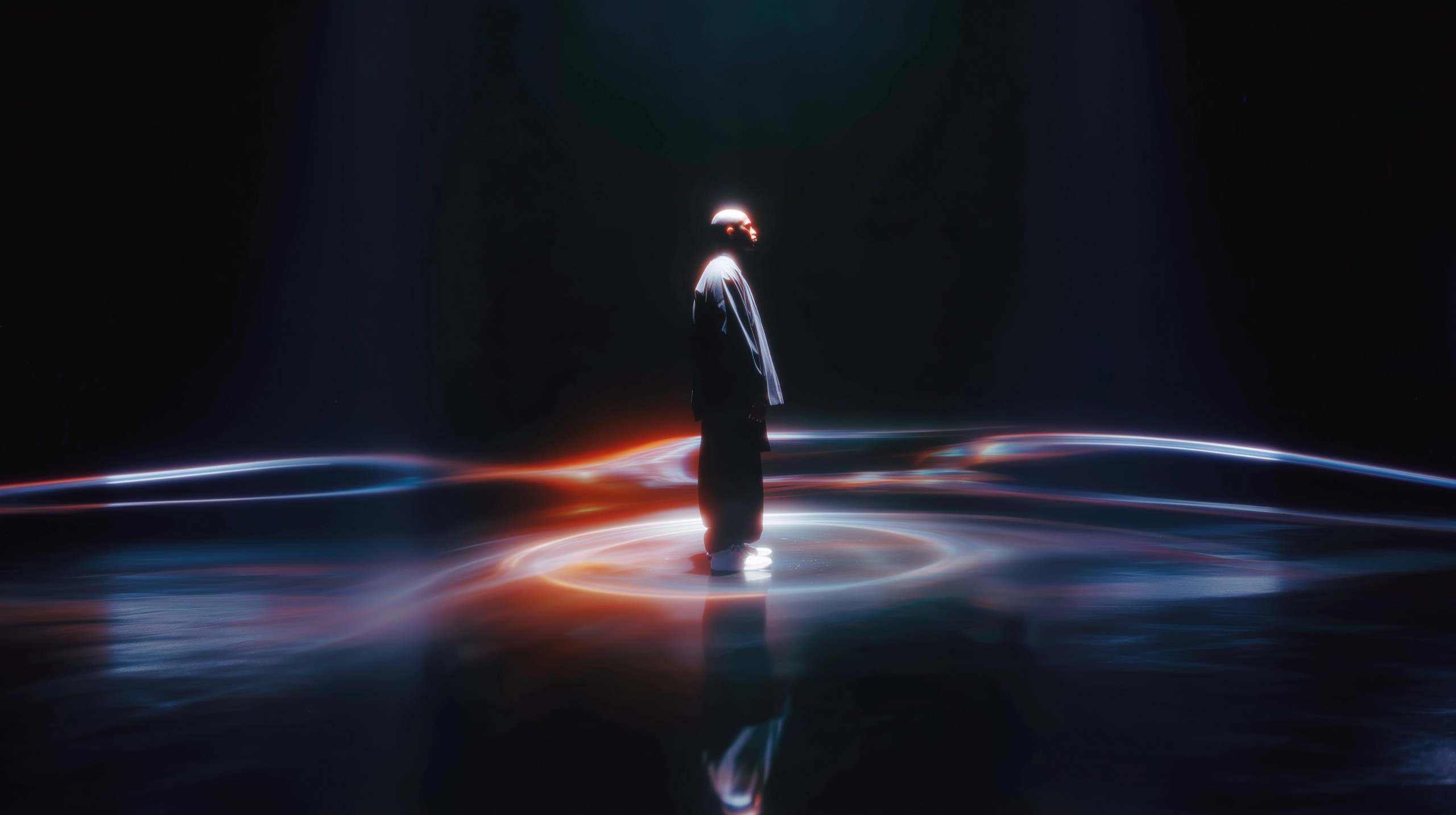 Figure standing in a ring of light on a dark reflective floor