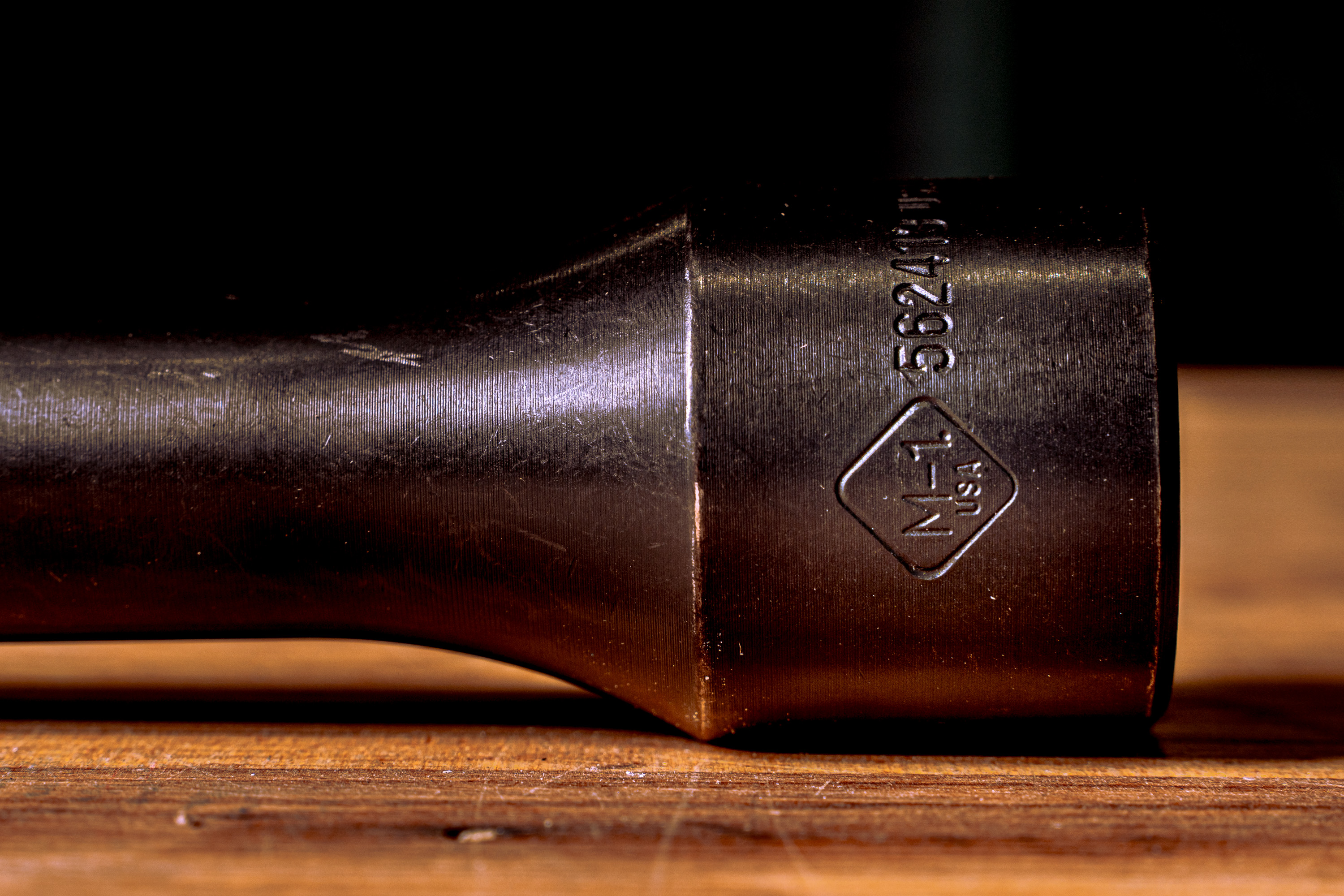Close-up of a black metal object with engravings reading 'N-1 USA' and '5624'.