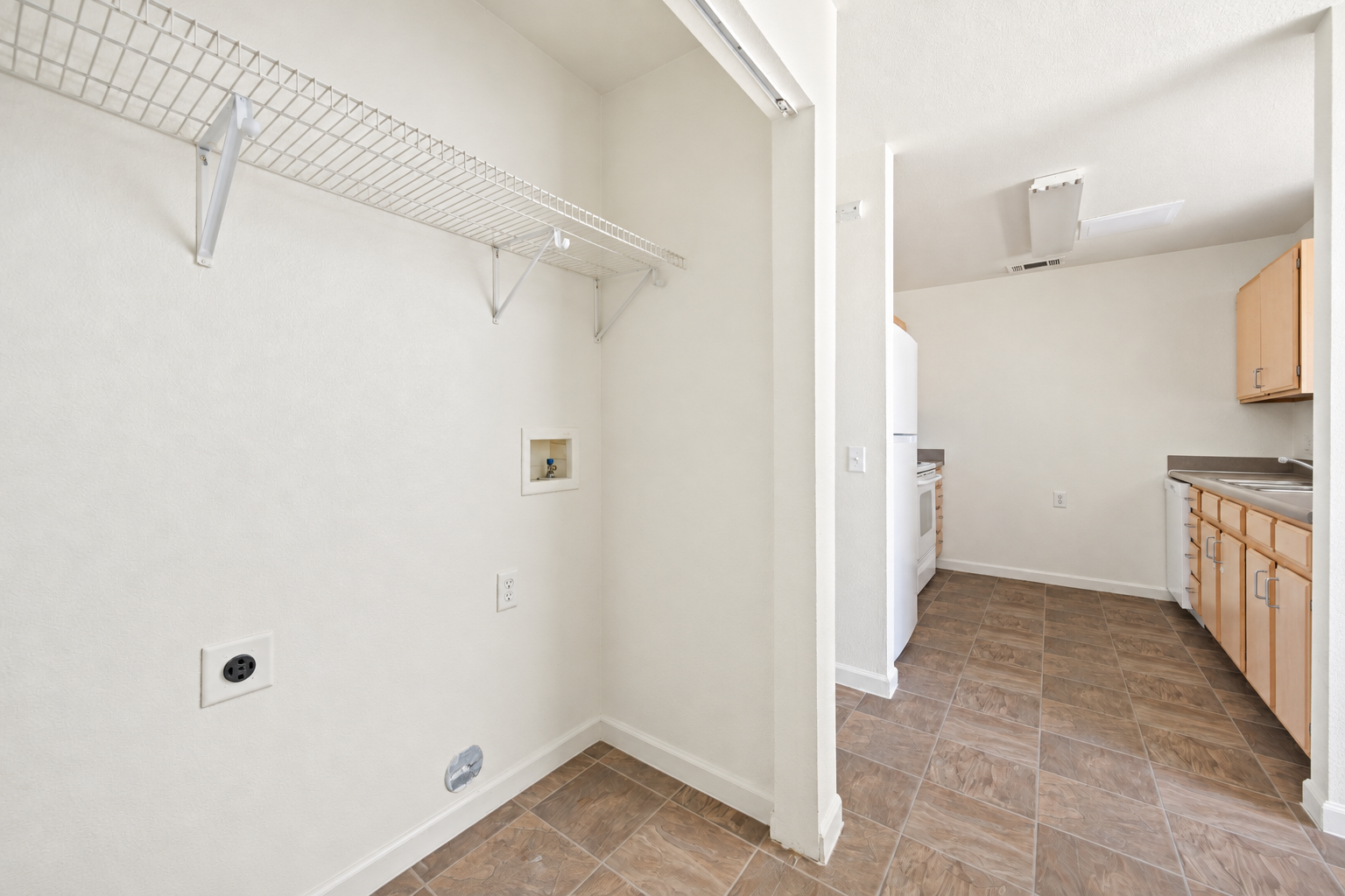 Laundry closet with washer dryer hookups 