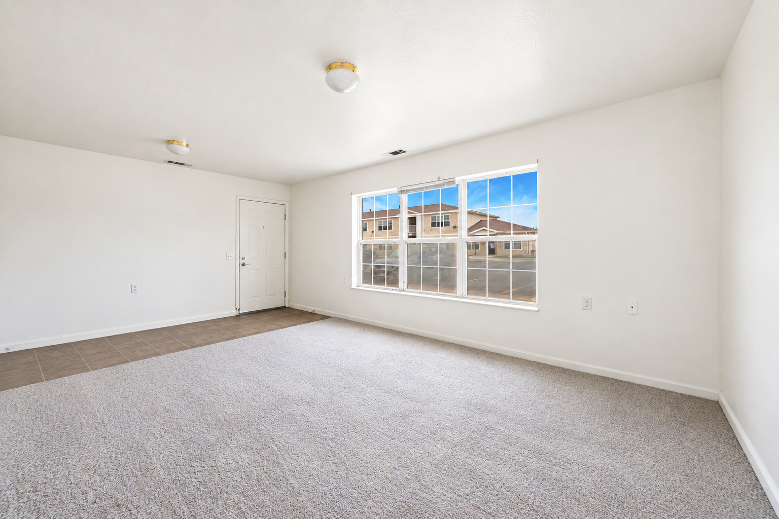 Living area unfurnished with large window