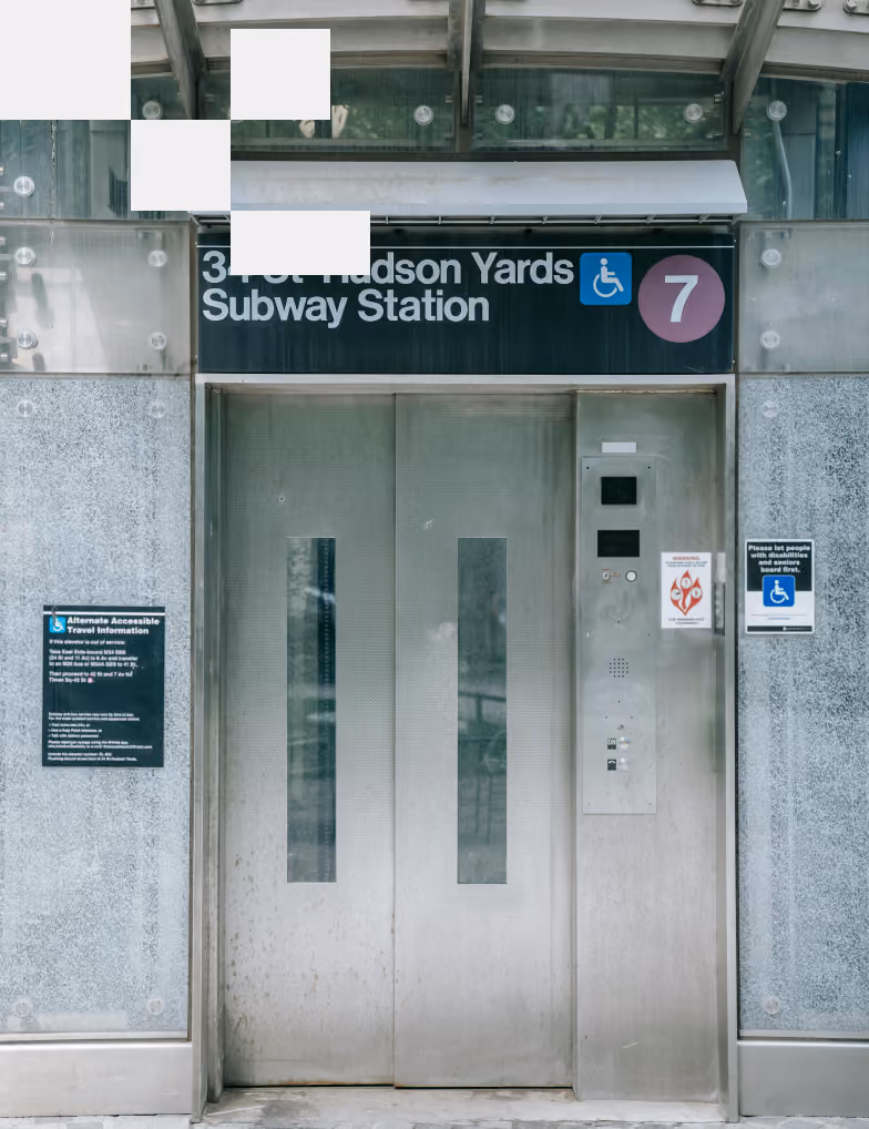 Elevator entrance at 34th Hudson Yards Subway Station with accessibility signs and elevator control panel.