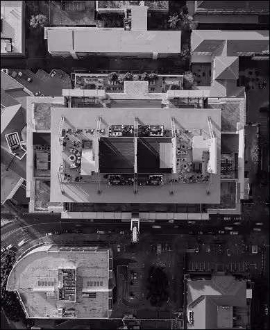 A top down view of a skyscraper centred around a city block. 