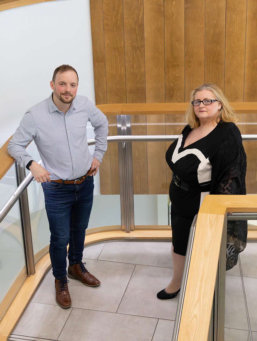 Kieran and Lisa smiling on a staircase