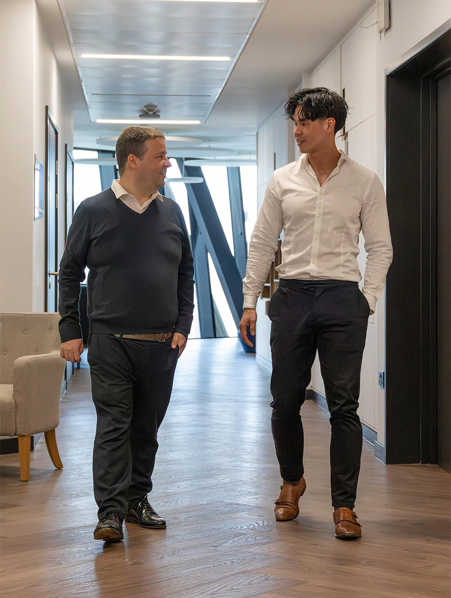 Matt and Liam walking down a corridor