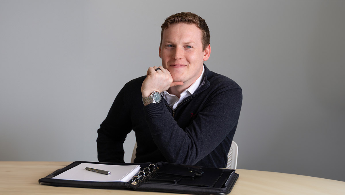 Jamie smiling sat at a desk
