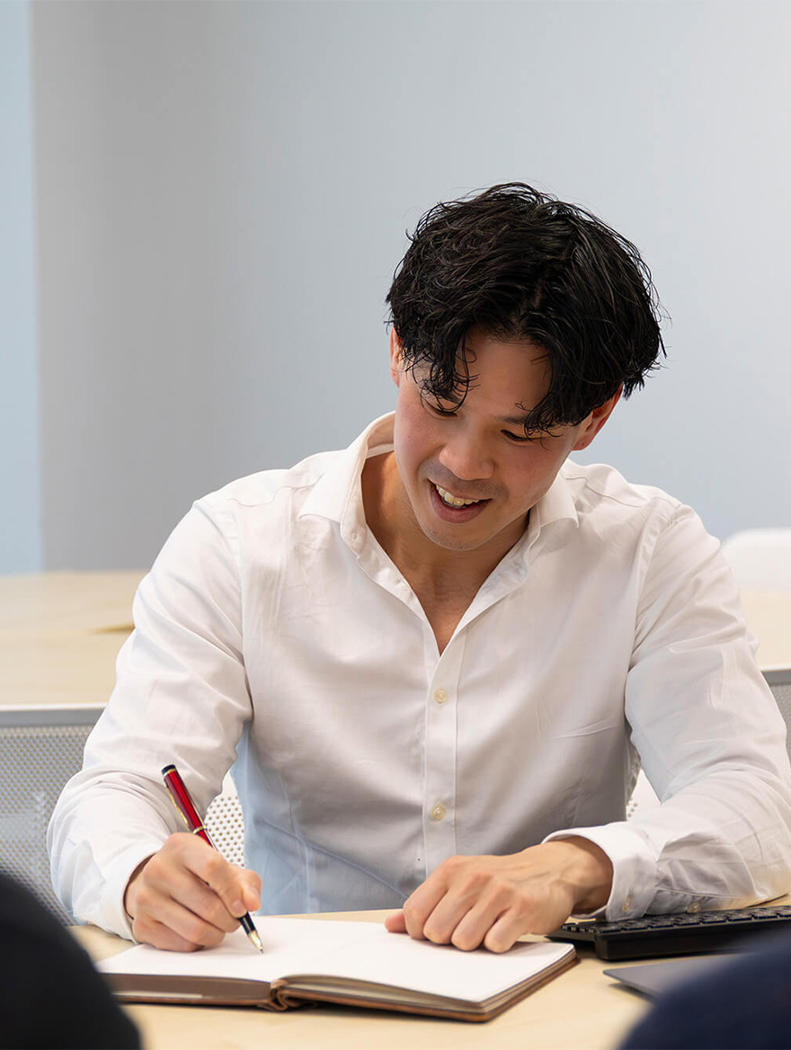 Liam taking notes during meeting