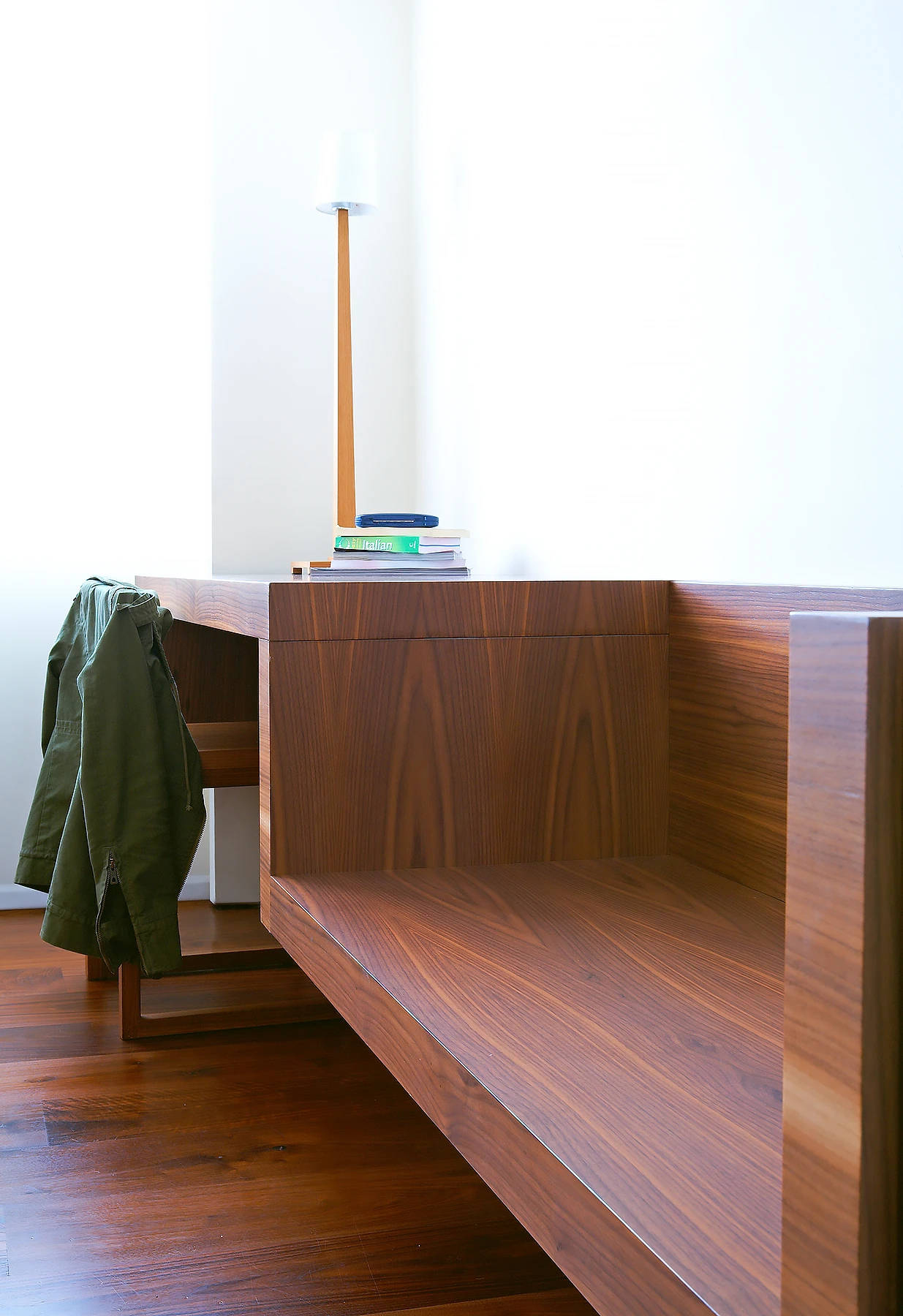 Bespoke fitted furniture. The desk and seat hang from the wall. 