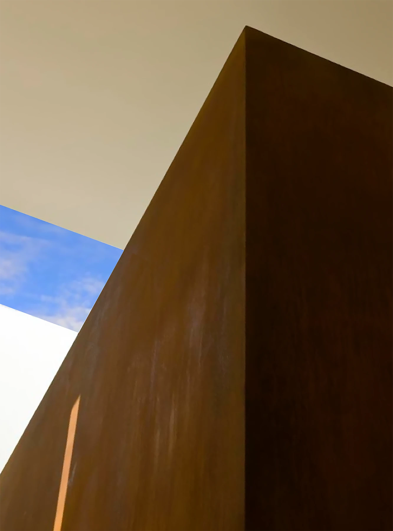 The entrance hall features a folded oak stair and a 7m high monolithic 'vase' formed from rusted steel, referencing the Richard Serra work near the client’s office. 
