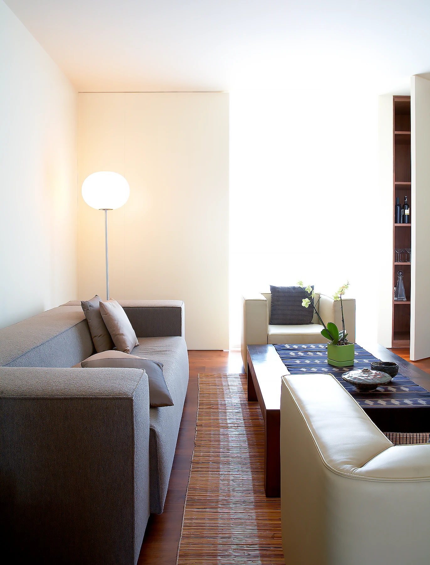 Front and rear façade walls are thickened to create hidden storage and layers of fabric filtering light. 