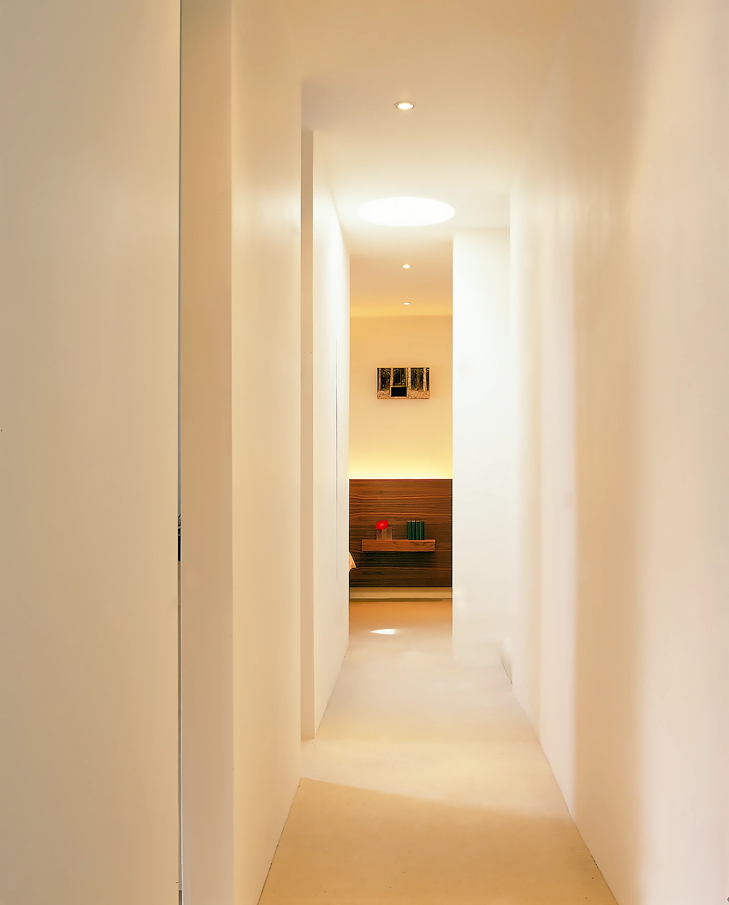 A hallway with each wall reflecting the divine geometric progression of Fibonacci. Westerly light penetrates the full length of the corridor. Colour-changing linear lighting beyond emulates the sunset as it dims. 