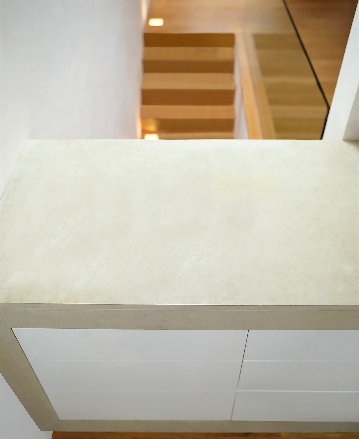 The stone island unit looks over the stairs and beyond, south of the Mayfair rooftops.