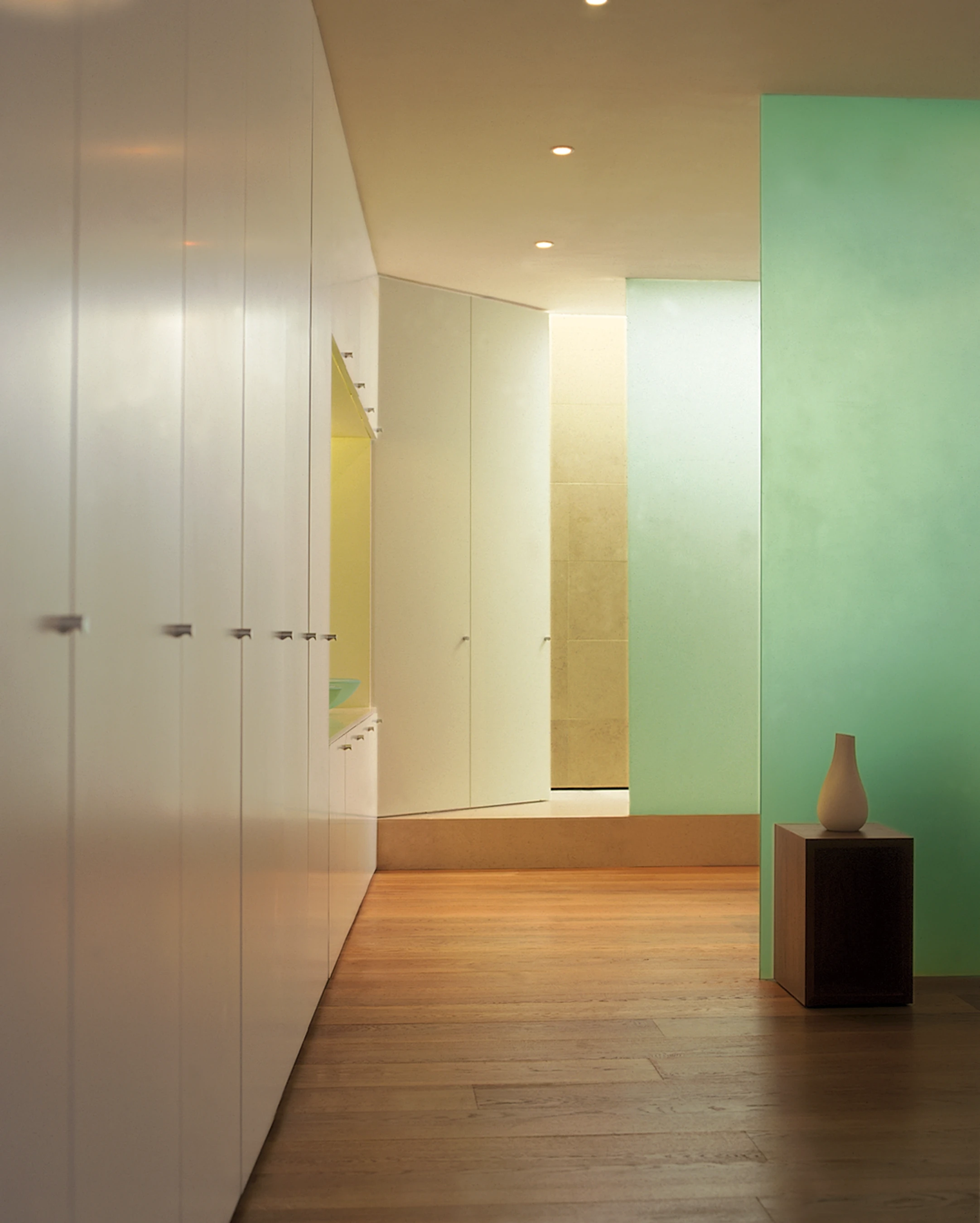 The principal bedroom has wall-to-wall storage, a double-ended bath and shower screened from view by etched glass walls.