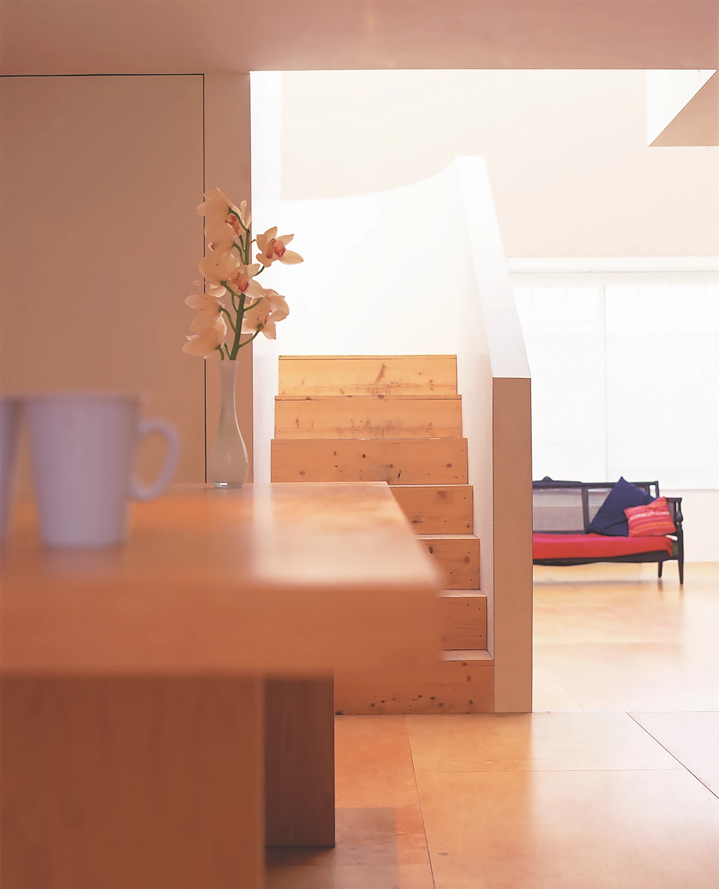 The entrance vista takes in the entire apartment, with single-, double-, and triple-height spaces. There is compression and release as you are drawn to the light.