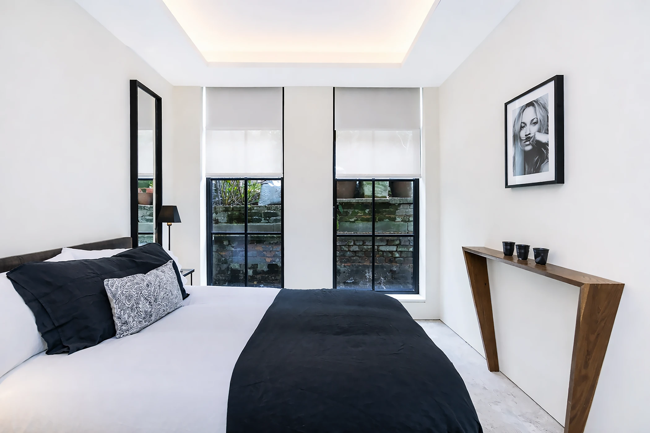 Second bedroom with strong symmetry and concealed lighting.