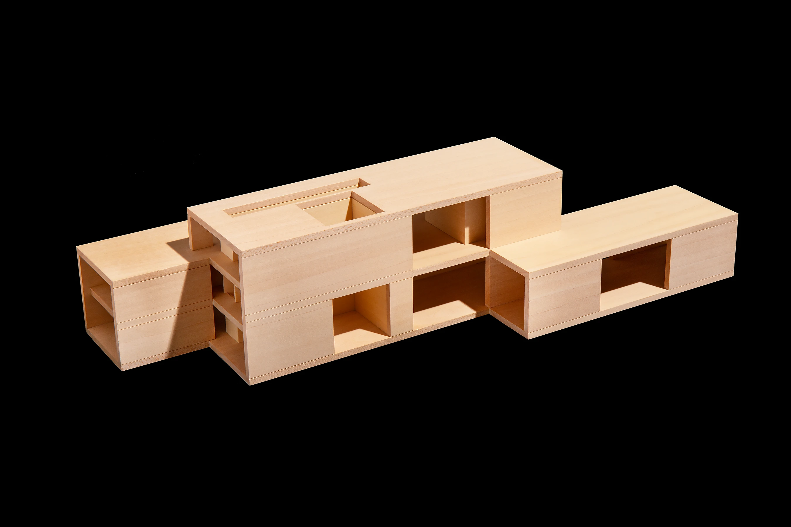 Conceived as three interlocking extrusions of two and three storeys. Made from smooth stone bands and textured stone panels. 