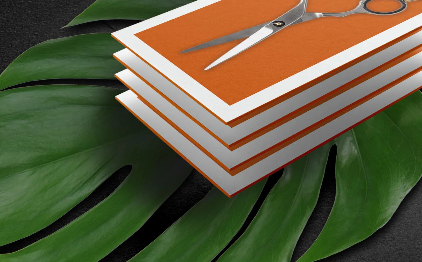 De León stacked business cards with barber shears