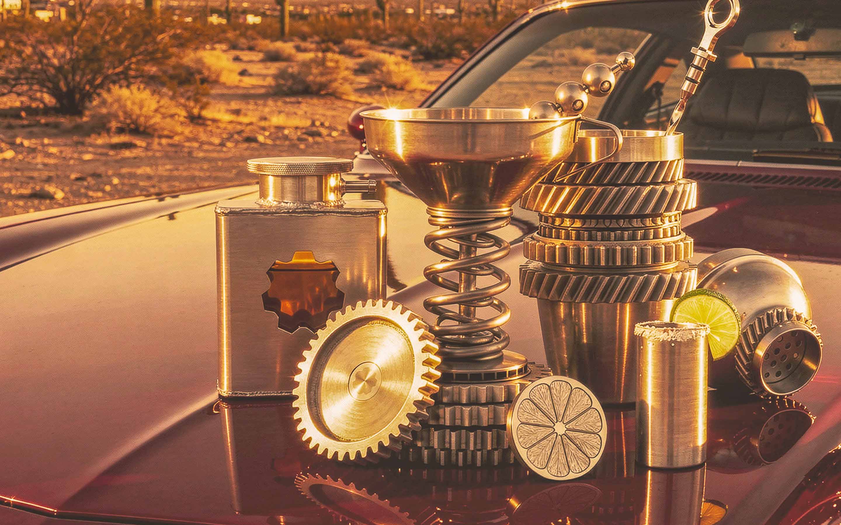 Gearbox metal drinkware arranged with automotive parts in a desert scene