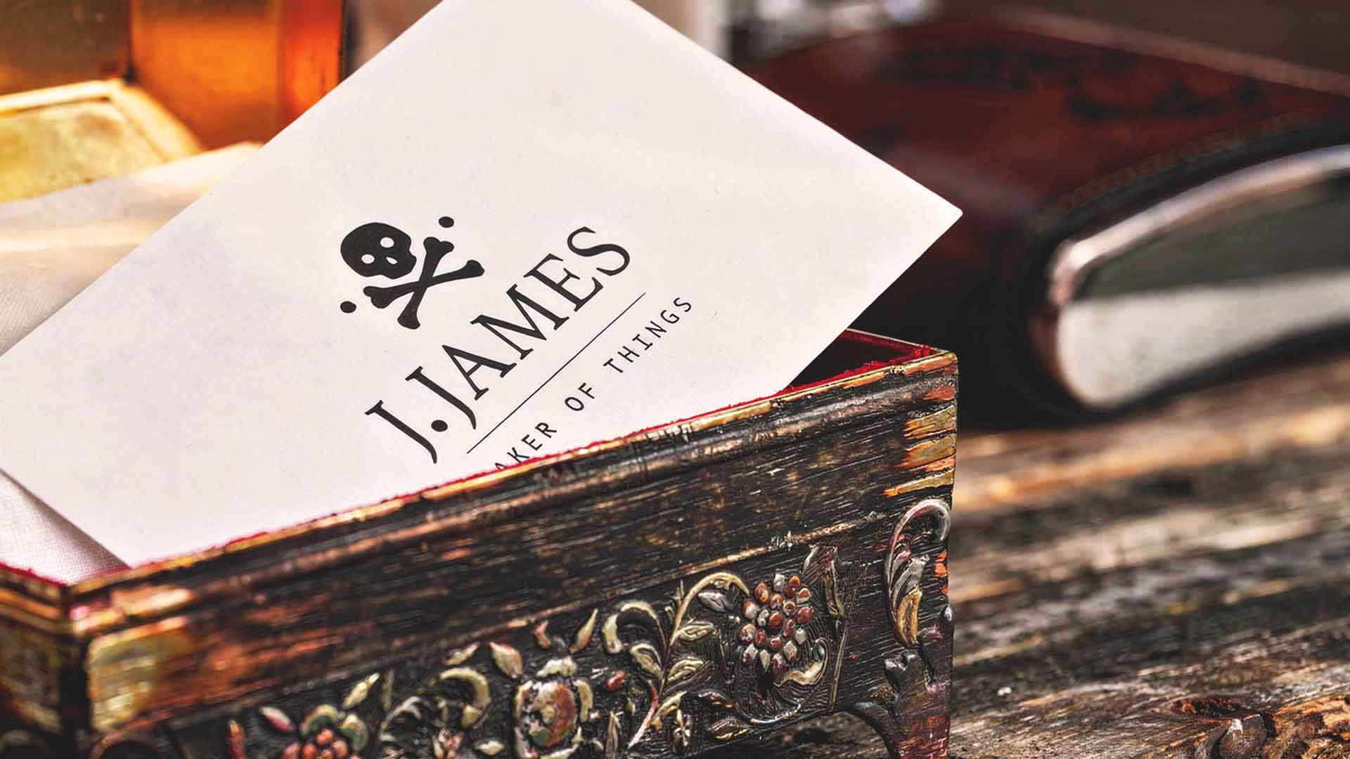 J. James business card with skull logo