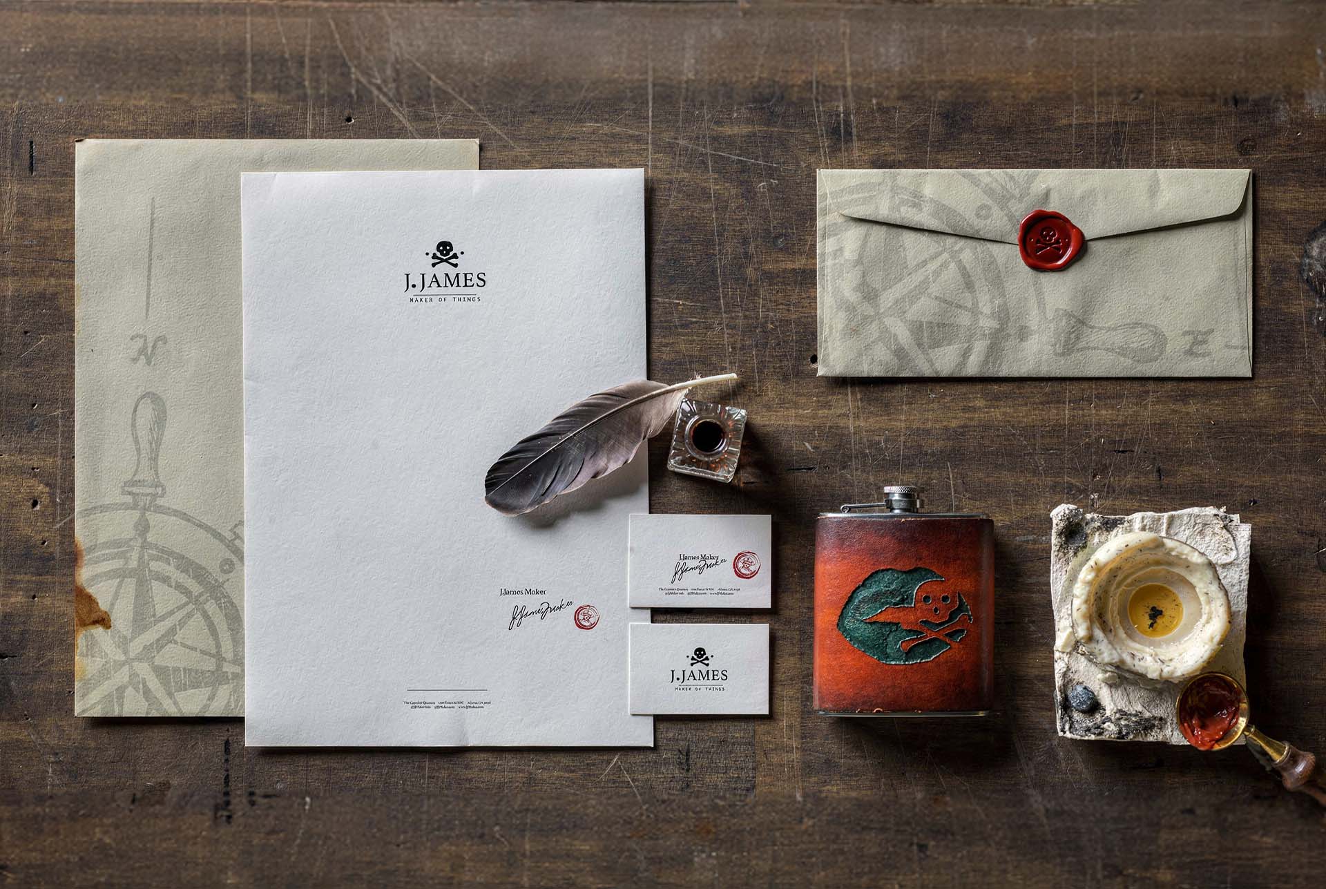 J. James branded stationery flat lay with a wax sealed envelope