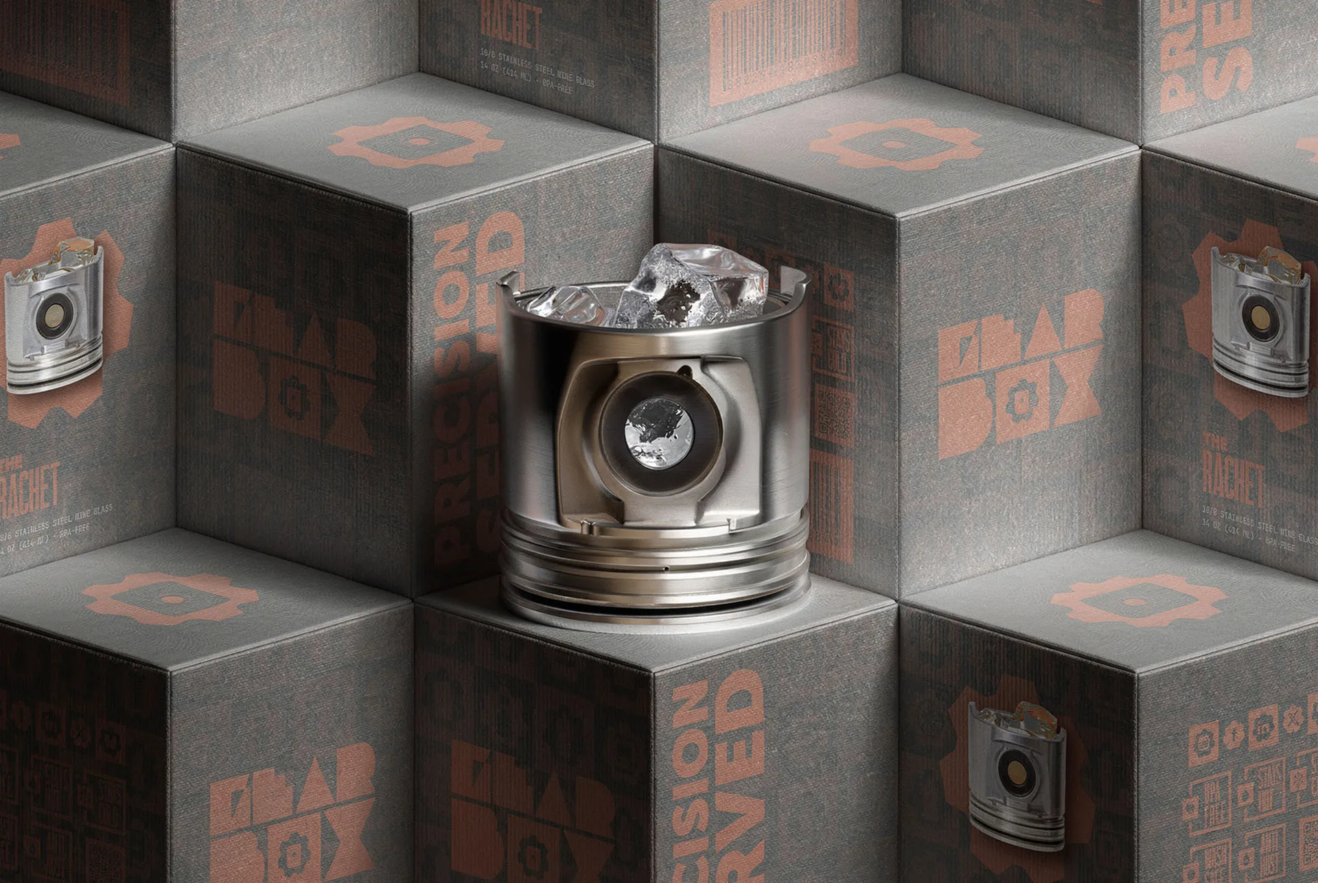 Gearbox packaging boxes stacked into a cube wall with a piston tumbler set in front of them
