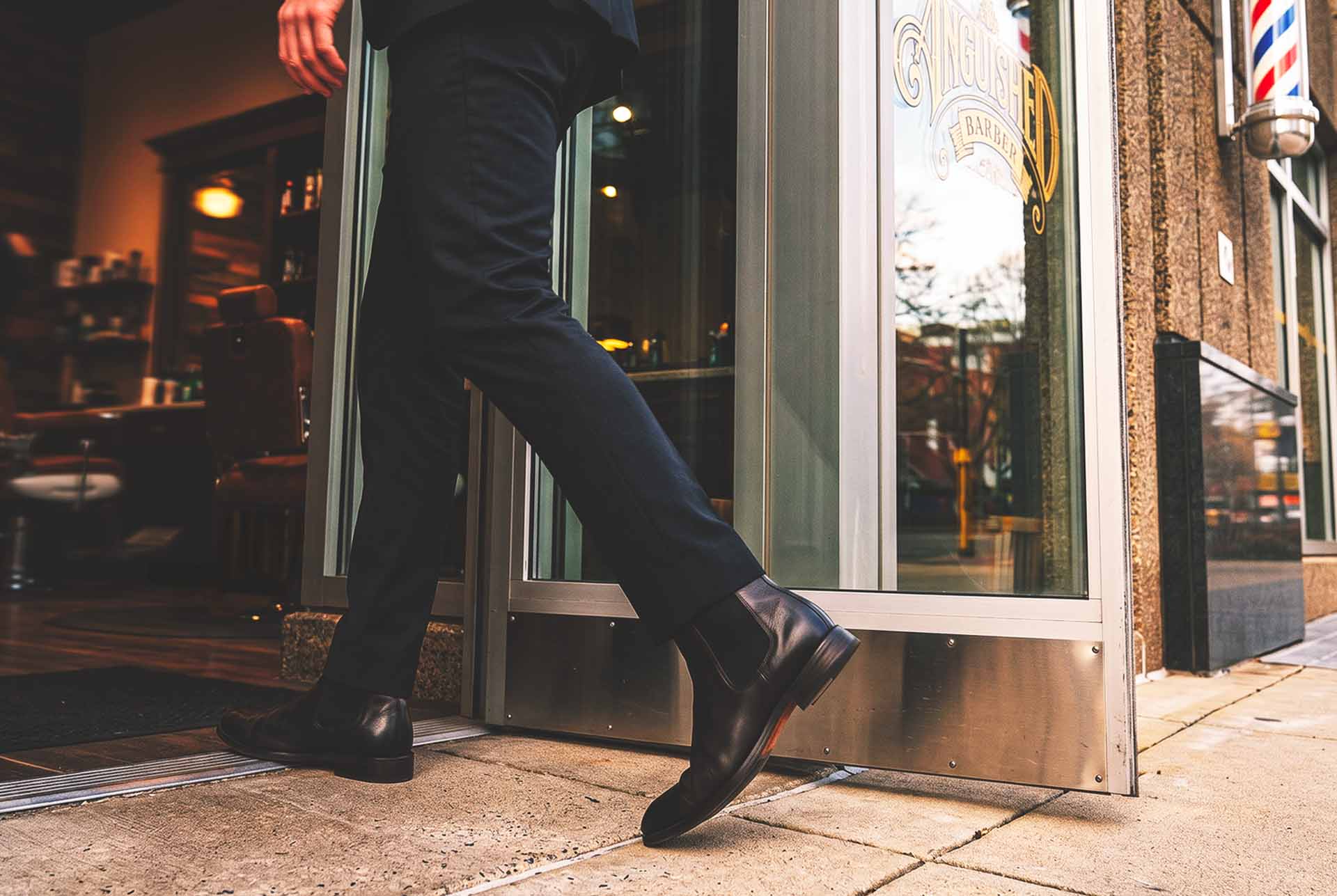 A client leaving The Anguished Barber in a suit