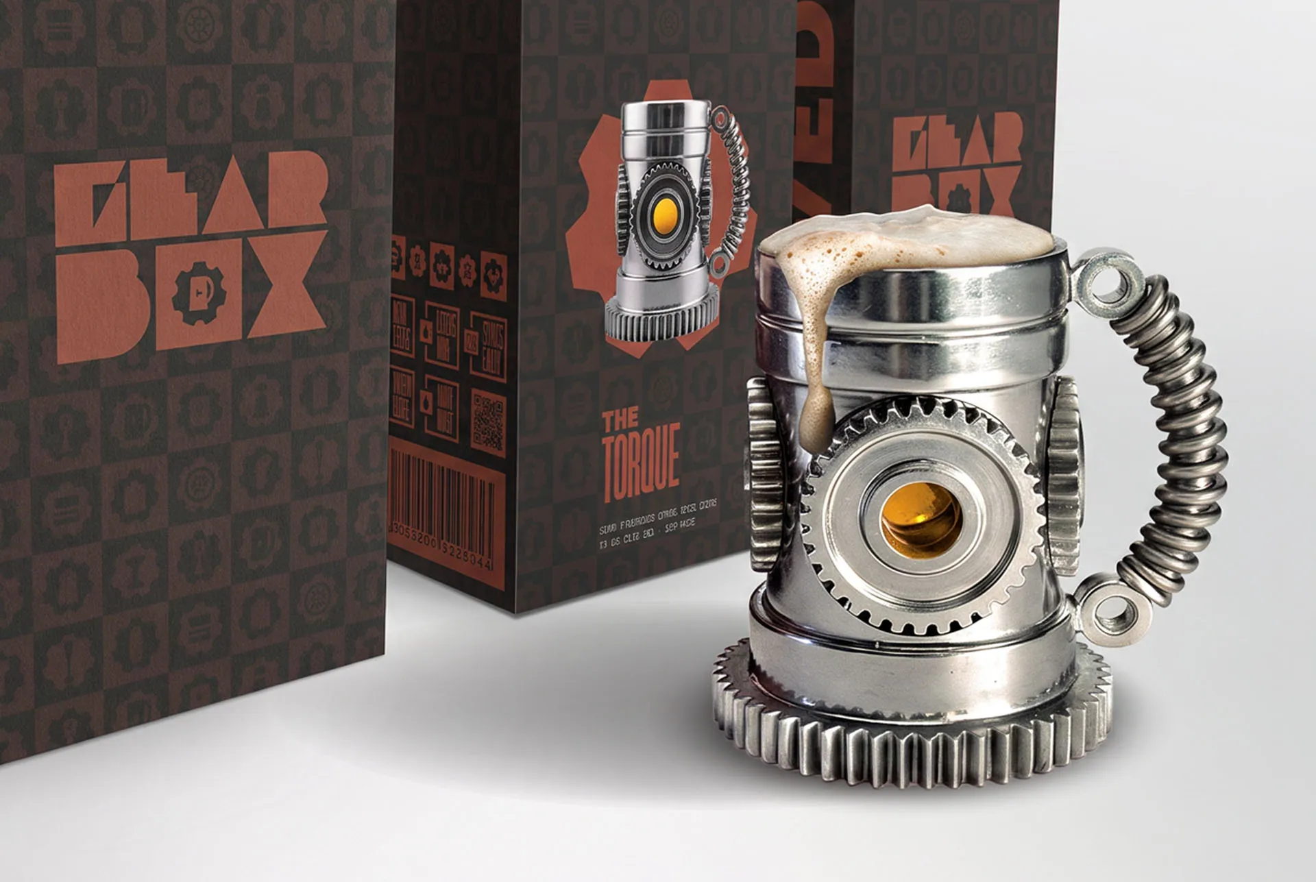 The Torque packaging box in the Gearbox pattern, standing beside the stacked gear tankard with a coil spring handle that it holds