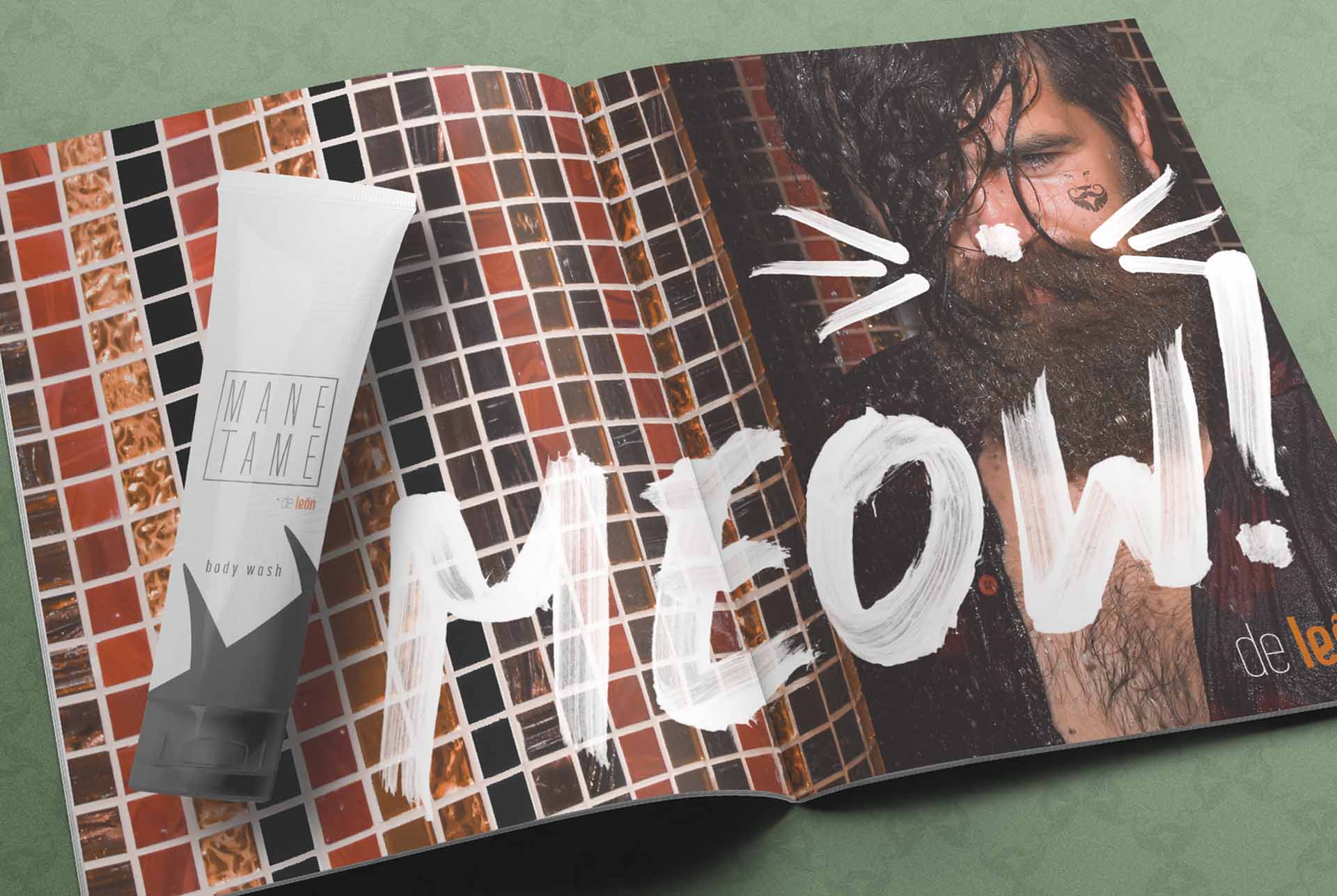 De León magazine spread with MEOW hand lettered across a bearded portrait beside a Mane Tame body wash tube
