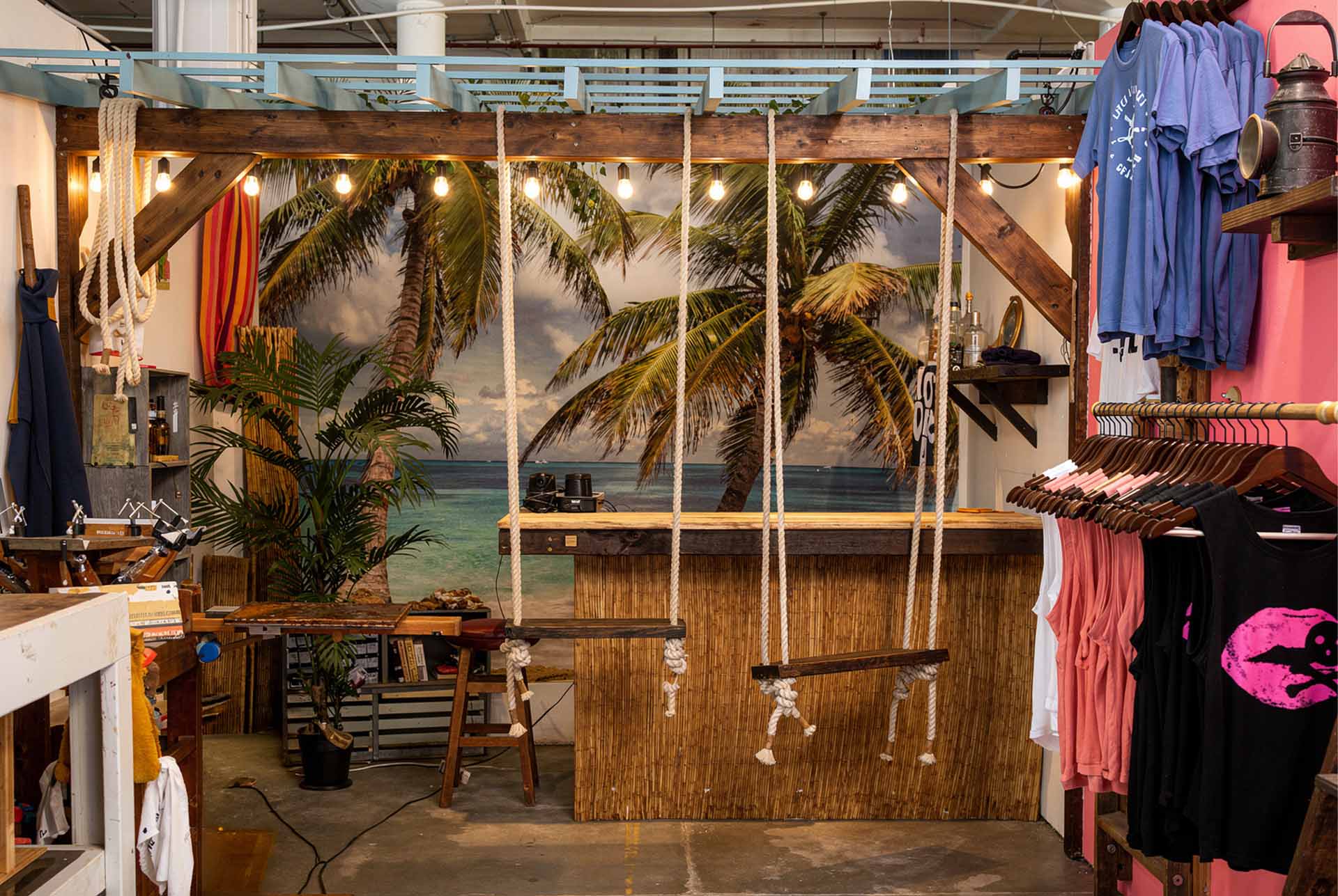 Casa Toucan interior with palm mural, thatch bar and rope swings