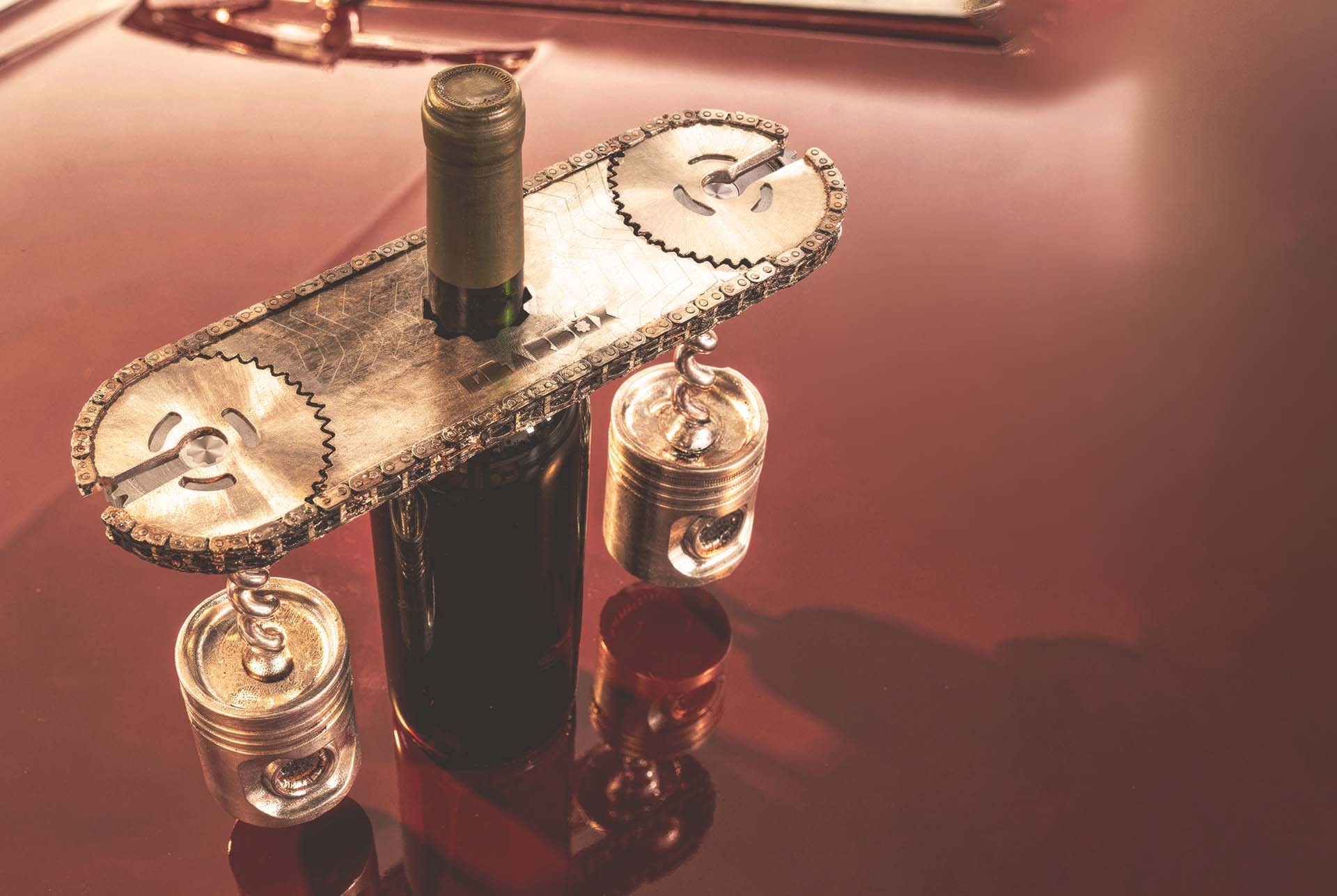 The Bracket deck holding a wine bottle through its slot, with a piston bodied corkscrew held magnetically beneath the plate