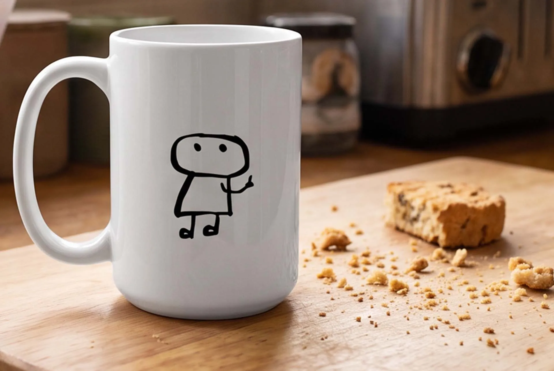 A white Good Mourning mug printed with the ghost character, beside a broken biscuit