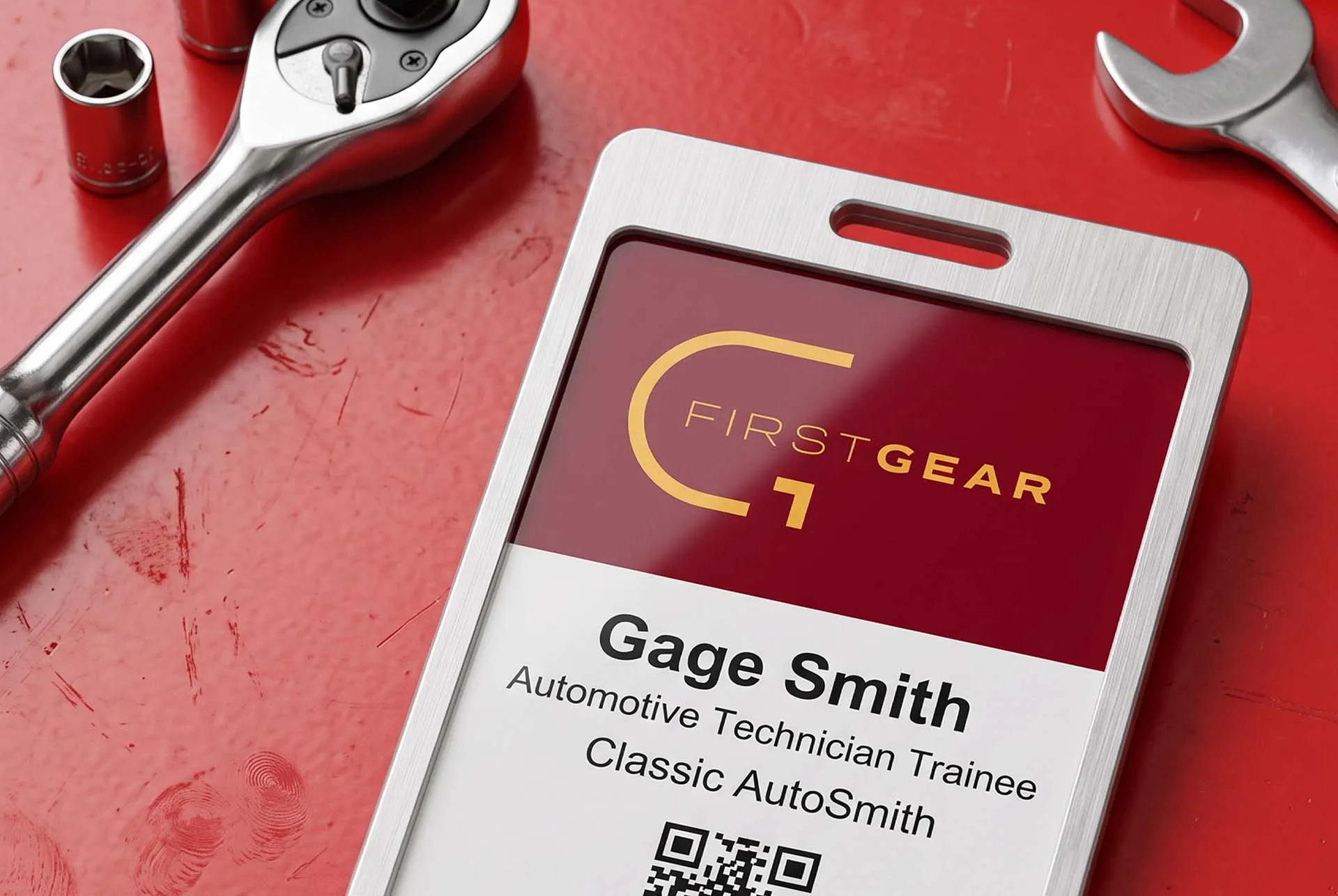 A First Gear ID badge for an automotive technician trainee lying on a red toolbox