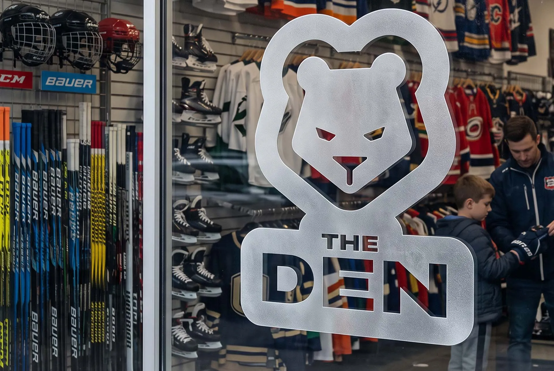 The Den logo hanging as a sign in a sports equipment store