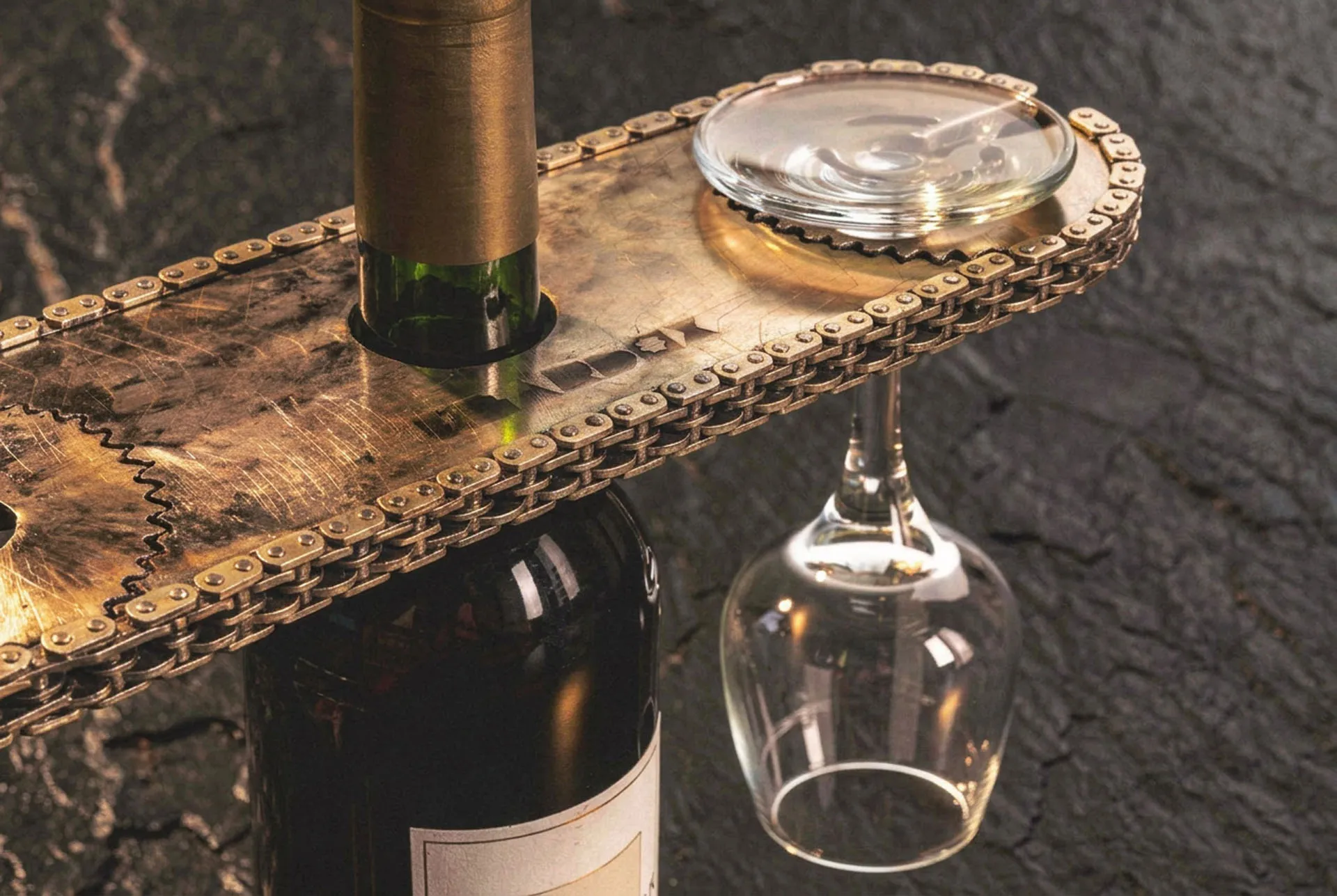 The Bracket in service, a wine bottle through the deck slot and a wine glass hanging by its foot from a cut slit