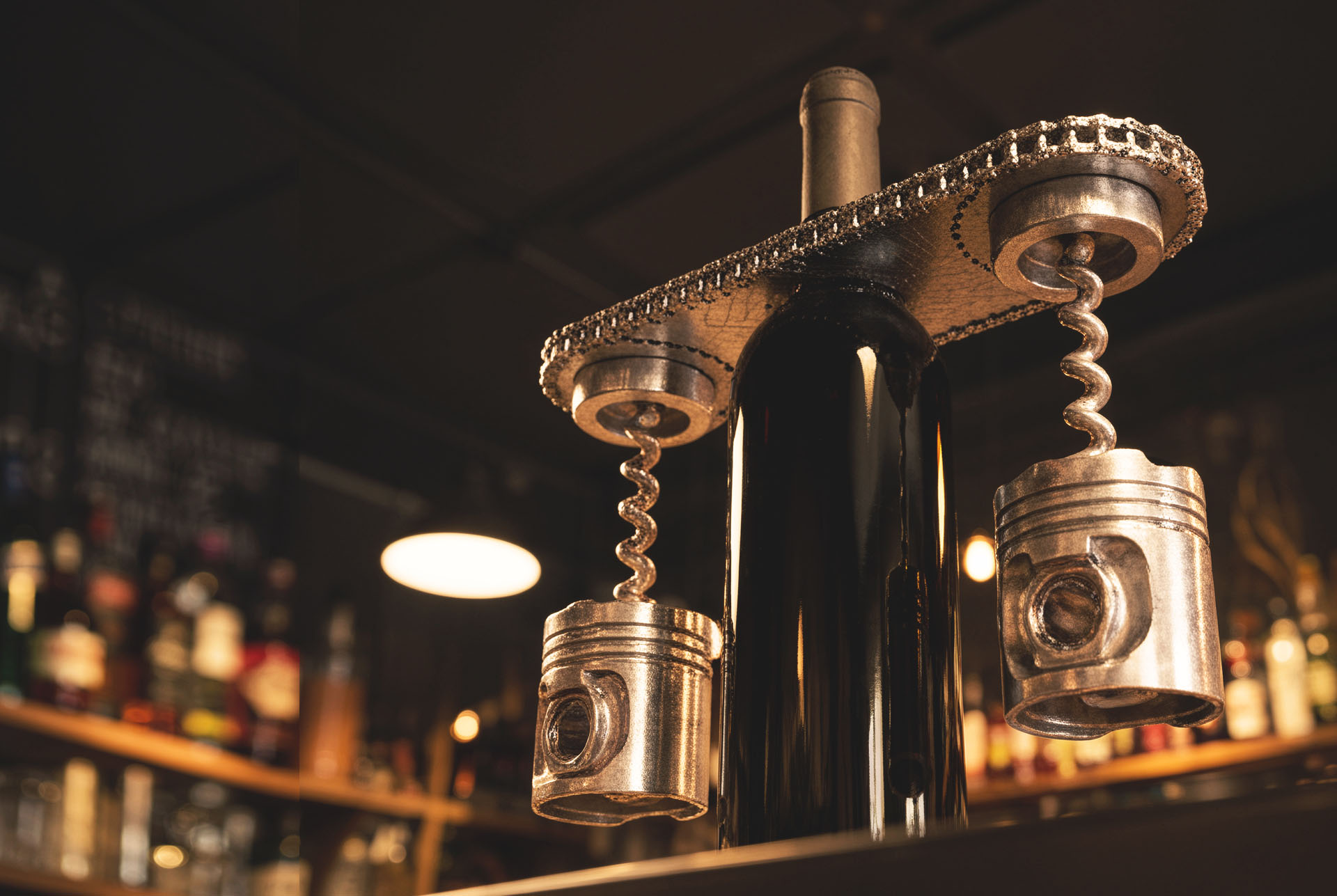 The Bracket wine caddy holding a bottle at a bar, with piston-bodied corkscrews, Gearbox product design
