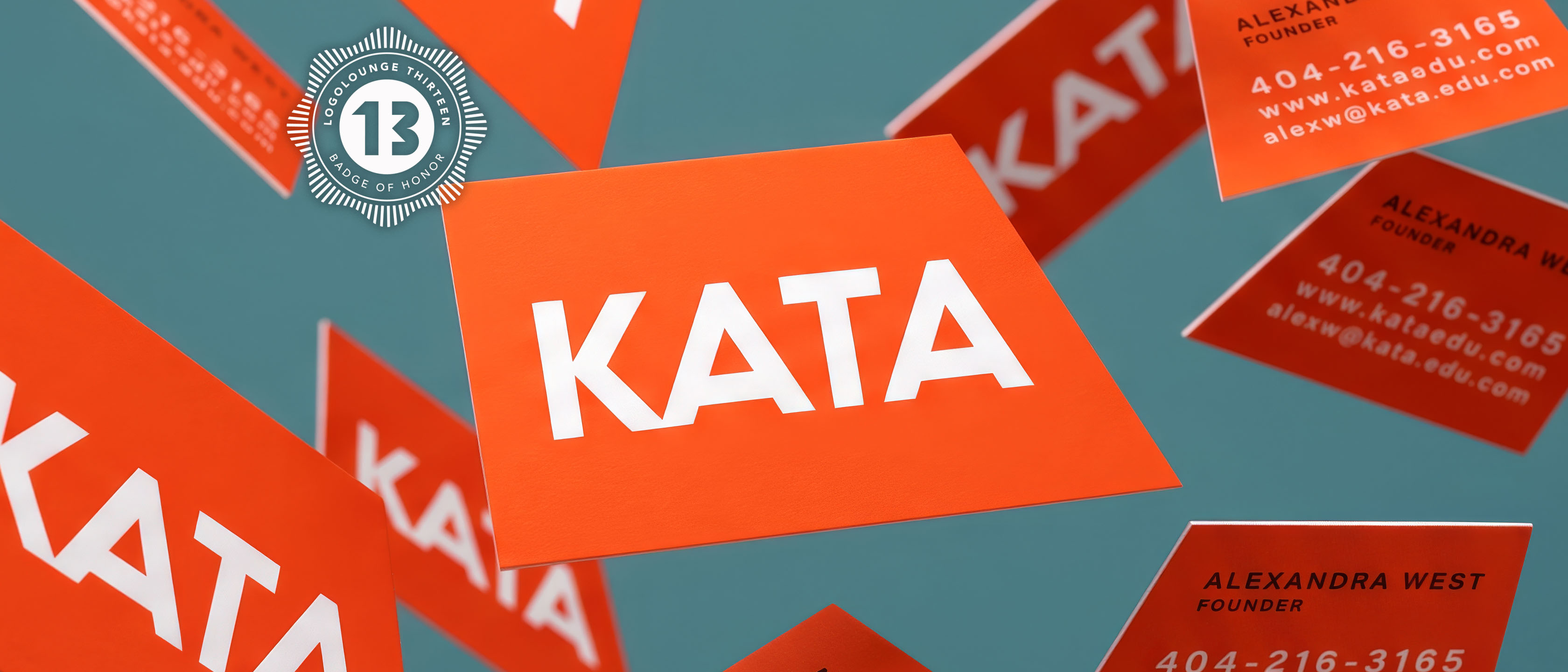 Orange KATA business cards scattered across a teal surface, the wordmark on the top card, with a LogoLounge 13 seal alongside