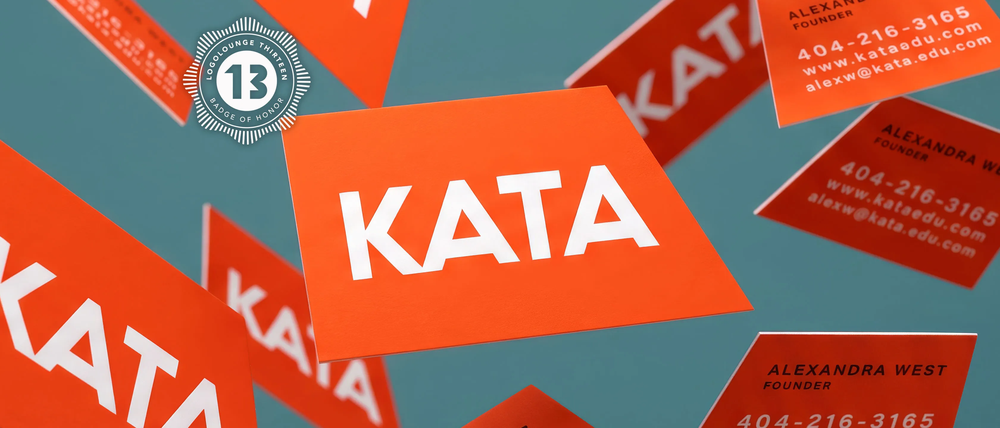 Orange KATA business cards scattered across a teal surface, the wordmark on the top card, with a LogoLounge 13 seal alongside